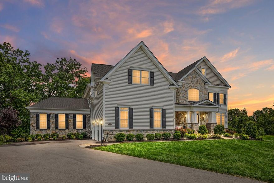 **OFFER DEADLINE MON 9/15 5PM**List Price is the Appraised Value on 8/25/25. Welcome to this extraordinary Toll Brothers Hollister Country Manor estate home, perfectly situated on a premium cul-de-sac lot backing to trees and open space in the prestigious gated golf course community of Dominion Valley Country Club. Built in 2019 this well crafted home offers an exceptional blend of architectural detail, luxury finishes, and resort-style outdoor living. Step inside the dramatic two-story foyer, where a dual-turned staircase, shadowbox molding, crown molding, and board-and-batten accents set the stage for the home’s refined character. The formal living and dining rooms feature designer trim details, while engineered hardwood floors flow seamlessly throughout the main level. A private office with custom built-ins provides the perfect setting for working from home. At the heart of the home, the ultra-chef’s kitchen is a true showpiece. Designed for both culinary artistry and entertaining, it features white shaker cabinetry with glass accents, under-cabinet lighting, an expansive island with pendant lighting, a commercial-grade range with vent hood, wall oven, granite countertops, a subway tile backsplash, a built-in 42” refrigerator, and a spacious walk-in pantry with wood shelving. Stainless steel GE Monogram appliances complete this gourmet space. Double sliding doors open to the backyard oasis, creating an effortless indoor-outdoor flow. The expanded family room, anchored by a marble-surround gas fireplace, is open to the breakfast area and kitchen, making it an ideal gathering space. The main level also features a multigenerational suite addition, complete with its own family room, spacious bedroom, full bath with walk-in shower, and a large walk-in closet perfect for guests or extended family. A custom mudroom with built-in drop zone and ceramic tile floors adds everyday convenience. Upstairs, the primary suite is a private sanctuary, featuring a tray ceiling, sitting room, and three custom walk-in closets. The spa-inspired primary bath offers a freestanding soaking tub, dual vanities, custom built-ins, a luxurious rain shower with bench seating, and a private water closet. Four additional spacious bedrooms, each with its own en-suite bath, complete the upper level. The finished basement provides an expansive recreation area, a stylish dry bar, a game area with Offenbachers game room included (shuffleboard, dartboard, air hockey, foosball, bar set with mirror, pool table and light fixture, stools, and billard rack), and a large storage room with potential for future expansion. Outdoors, no detail has been overlooked in creating the ultimate retreat. The backyard oasis boasts a heated gunite pool, spa, pavilion with a wood-burning fireplace, travertine tile, built-in ceiling heaters, expansive trex deck with built in kitchen and dedicated natural gas line, speakers, and multiple entertaining areas all surrounded by the natural beauty of the private, tree-lined setting. Additional highlights include Anderson windows, a three-car side-entry garage with openers and keypad, slate walkway and porch, and premium finishes throughout. As a resident of Dominion Valley Country Club, you’ll enjoy an unparalleled lifestyle with access to a renovated clubhouse, Arnold Palmer-designed golf courses, a sports pavilion, fitness center, indoor and outdoor pools, tennis and pickleball courts, basketball courts, sand volleyball, scenic walking trails, playgrounds, and stocked fishing ponds. Fitness and golf memberships are available, with award-winning schools located right inside the community. Convenient access to major commuter routes, as well as upscale shopping and dining, complete this incredible offering. Don’t miss the opportunity to call this exceptional estate home. Schedule your private tour today and discover a lifetime of Saturdays in Dominion Valley Country Club.