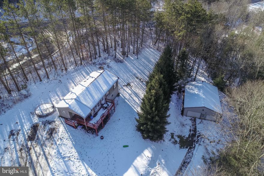 Opportunity awaits on nearly 4 acres! This 3-bedroom, 2-bath raised rancher is  full of potential for the right buyer ready to add their personal touch. Set on just under four acres across two separate lots, this property offers space, privacy, and flexibility for future use or expansion. The home features a functional layout with generous room sizes and solid bones, making it an ideal candidate for renovation, investment, or a value-add project. Outside, you’ll find a large detached garage perfect for vehicles, equipment, hobbies, or extra storage—an added bonus for contractors, outdoor enthusiasts, or anyone needing workspace. With acreage that’s hard to find and endless possibilities, this property is a great opportunity to build equity and create something special. Bring your vision and unlock the potential this property has to offer!