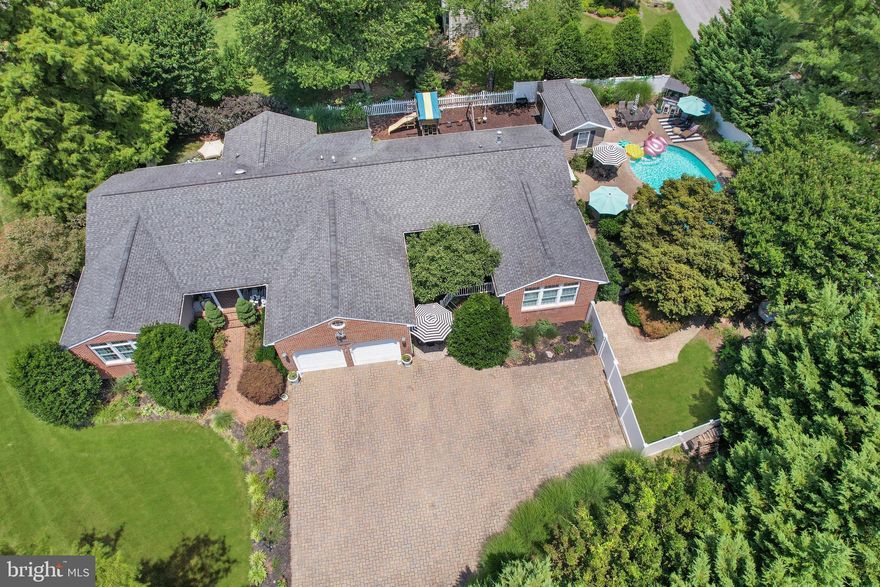 IMPT! FINAL AND BEST OFFERS DUE BY 6:00 PM MONDAY JULY 24TH. NO ESCALATION CLAUSES PLEASE. 
PUBLIC OPEN HOUSE: SATURDAY 7/22, 11-1 PM!This is it! Over 3700 sq ft – Brick Front Rancher. Entertainers Paradise. Enjoy your own private ½ acre Oasis relaxing in your beautiful Gunite pool with stone waterfall and adjacent gazebo as well as a firepit area for the fun evening campfires and a poolside ½ bath too! Enter this beautiful Annapolis home on the Broadneck peninsula through the lighted brick columns onto the long stone paved driveway that will accommodate 6+ vehicles plus an attached 2-car garage with auto door openers. Gorgeous landscaping and extensive hardscaping abound.  This home has many fine features including 4+ bedrooms, 4 full baths, hardwood flooring throughout the main level, recessed lighting, crown molding, public water and sewer, high efficiency (gas heat), back-up Generac generator, multiple gas fireplaces and much more. The updated kitchen boasts white cabinetry, granite countertops and 2-year new black stainless appliances. The home chef will enjoy cooking on the 5-burner stove with convection oven.  The spacious primary bedroom has an en-suite bath with jetted tub and separate tiled shower with multiple heads. Also, dual walk-in closets, gas fireplace and an attached sunroom/office with steps to the pool. Bonus – There is an attached (17x16) home office/guest suite that has a private separate entry (owner uses as a home salon). The lower level is fully finished and could be used as an in-law/au pair suite as it has a built-in kitchenette, full bath, and separate entrance. 
Great access to Rt 50, Downtown Historic Annapolis, waterfront restaurants, marinas and more! Broadneck schools too! Enjoy all that living in Annapolis and the scenic Chesapeake Bay area has to offer. Won’t Last!!