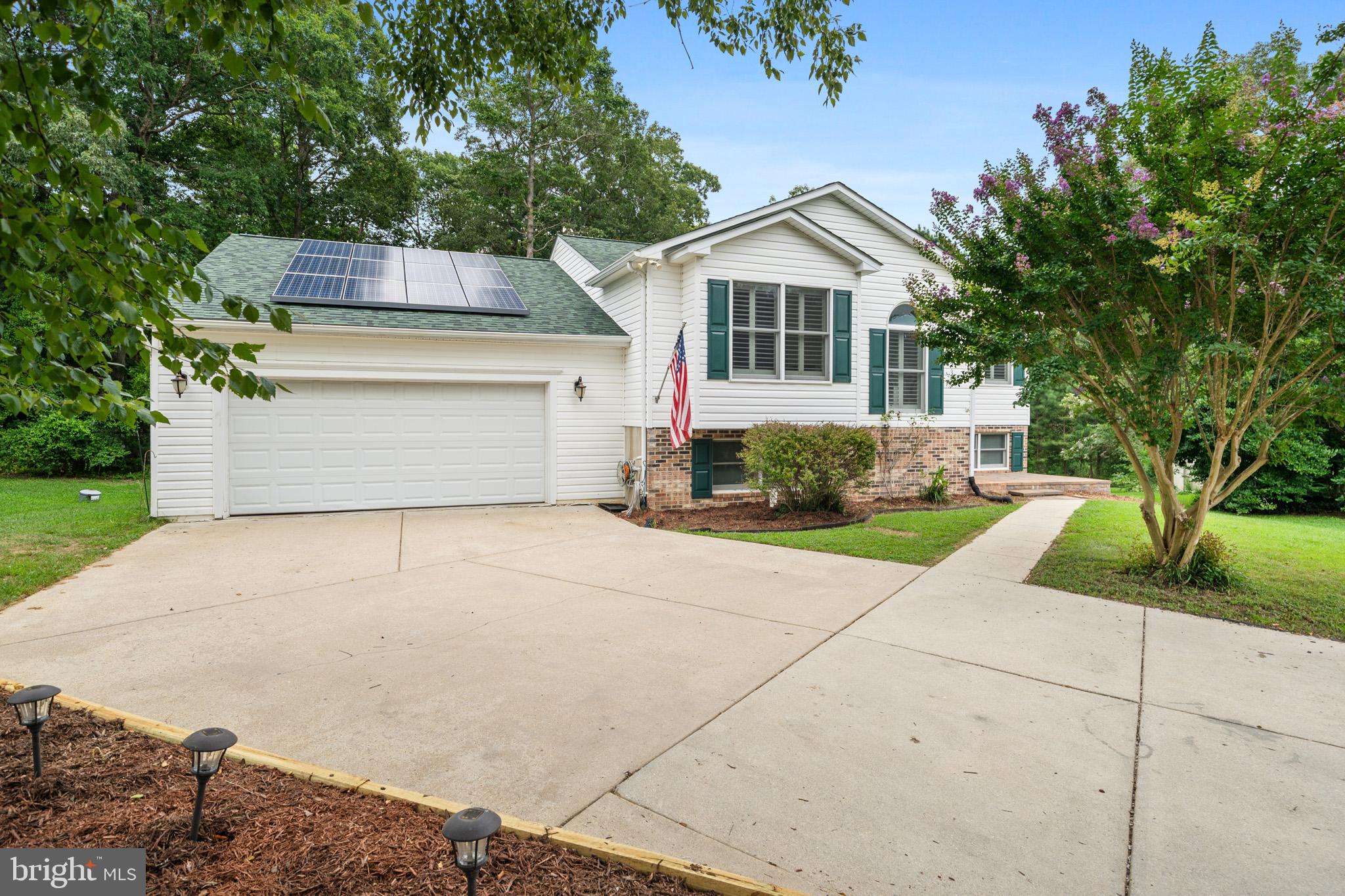 Tremendous Value! Immaculate Home with Huge Gargage! This beautiful home offers over 2,000 sqft of living space, including a primary bedroom with it's own private bath on each level. The spacious kitchen is equipped with stainless steel appliances. The oversize garage with a loft allows for plenty of extra storgage space. Enjoy a low energy bill due to the solar panels installed on the home. Relax on the the large deck backing to trees. Situated at the end of a cul-de-sac for a little added privacy, and only minutes from PAX River Navel Base, this amazing home will be sure to impress. Call today to schedule a time to view this great home!