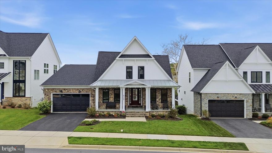 Welcome to one of Landsdale’s most extraordinary homes — a thoughtfully designed, extensively upgraded, and beautifully customized Wormald Eastwood Model that was never meant to be sold.
Built by one of Frederick County’s most sought-after luxury builders, this exceptional home showcases top-tier builder selections plus extensive seller enhancements that make it truly one of a kind. From the moment you arrive, the difference is clear. The expansive full front porch immediately sets this home apart and may be one of the only Wormald homes in the community with this rare feature. Perfectly situated on a premium lot backing to permanent greenspace, trees, and nature, this property offers privacy, beauty, and views that are nearly impossible to replicate. The outdoor living spaces are spectacular. The backyard has been transformed into an entertainer’s dream with custom hardscaping, an oversized patio, firepit area, sitting wall with lighting, built-in protection from the elements, maintenance-free Trex stairs, and an enormous extended Trex deck measuring approximately 19’ x 16’. Whether hosting a crowd or enjoying peaceful wooded views, this setting is perfection. Inside, every detail has been elevated. A spacious main-level study features custom built-ins, recessed lighting, beautiful flooring, large windows, and a closet, allowing it to function as an office, library, or potential fifth bedroom. Across the hall, the formal dining room offers generous space for elegant entertaining. The heart of the home opens into a breathtaking kitchen and family room, where walls of glass frame the stunning natural backdrop. The gourmet kitchen features high-end appliances, smart screen refrigerator, 8-burner gas cooktop, stainless vent hood, waterfall quartz breakfast bar, quartz countertops, custom backsplash, upgraded lighting, dimmer switches, and a fabulous walk-in pantry. The adjoining family room is equally impressive with custom built-ins, beautiful woodwork, and a fireplace for cozy evenings. A tablet-controlled speaker system extends throughout the home, allowing different music in different rooms for effortless entertaining. Just off the breakfast area, a beautiful three-season room provides another space to relax and enjoy the gorgeous views while protected from the elements.
The main-level owner’s suite is a private retreat with tray ceiling, mood lighting, remote-controlled blackout blinds, generous walk-in closets, and a luxurious bath featuring dual vanity, private water closet, designer tile shower with bench seating, and linen closet. Also on the main level are a stylish powder room, laundry room, two-car garage, and designer organizer nook. Upstairs, a versatile loft creates the perfect gaming area, study zone, second family room, or lounge. Two well-appointed bedrooms and a full hall bath complete the upper level. The finished walk-out lower level is fabulous, featuring a second fireplace, custom wet bar, and incredible cinema room with top-of-the-line speakers and screen. A fourth bedroom with large walk-in closet and beautiful windows overlooking the trees creates an ideal guest suite, while the full bath adds comfort and convenience. The lower-level walks directly out to the custom patio and sitting wall, seamlessly connecting indoor and outdoor living. Additional features include recessed lighting throughout, remote blinds, custom shutters, upgraded chandelier-style ceiling fans, extensive trim and built-ins, and a specially designed drain pump system under the front porch that moves sump pump water away from the home.
Landsdale is known for its incredible amenities and vibrant community lifestyle including weekly food trucks, movie nights, concerts, festivals, clubhouse events, walking trails, pools, playgrounds, and more. The brand-new elementary school adds convenience, and the location offers easy access to 270 & 70. This home is the perfect blend of luxury, functionality, views, and community living.