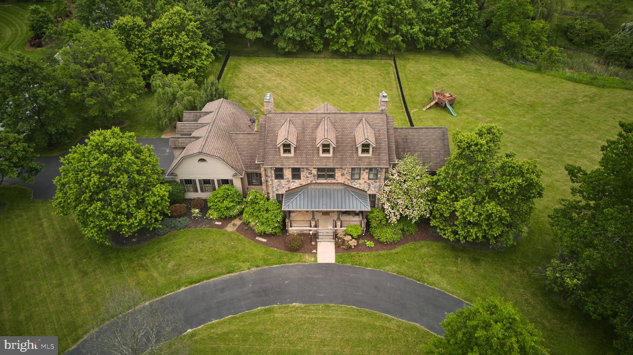 Stunning estate in the highly desirable Cedar Cliff neighborhood! This custom-built home boasts more than 5,200 sq. ft. of living space, with a massive light filled lower level that steps out onto an expansive 2.65-acre corner lot. Pull into your elegant circular driveway, featuring a welcoming covered front porch with slate steps. A side load driveway is conveniently accessible for additional guest parking. Step into your new home where you are greeted with a two-story foyer with a turned/curved staircase and expansive hardwood flooring on the main floor. The first floor features a cook's dream kitchen with 6 pot Viking stove and oversized refrigerator with beautiful tall custom cabinetry. This floor also features a mudroom with laundry off the side load 3+ garage. Continuing on the first floor is a large living room with a stone accent wall/fireplace with multiple arched ways leading to an office/living room, foyer and formal dining room. A first-floor large primary suite with tray ceilings and a massive walk in closet and primary bathroom. The second floor has 3 more bedrooms with one being a guest en suite and an additional large bonus room measuring 17x13 feet. The walkout lower level is expansive and features 3 sliding glass doors letting in plenty of natural light. This lower level features an additional large kitchen, additional laundry and a large family room with 2 more guest bedrooms and a large cellar area. Don't miss the 3+ bay workshop with a garage door and potential for heated floors if you are looking for additional space for hobbies. Enjoy the evening sunset on your large back deck or spend time roasting smores at the fire pit while your family and guests take in the beautiful backyard space, great for entertaining! This home features a well thought out floor plan and high-end efficient engineering including Geothermal heating and cooling, heated floors in the first level primary suite, twin water tanks and an advanced water filtration system to name a few. Call today for your private tour!
