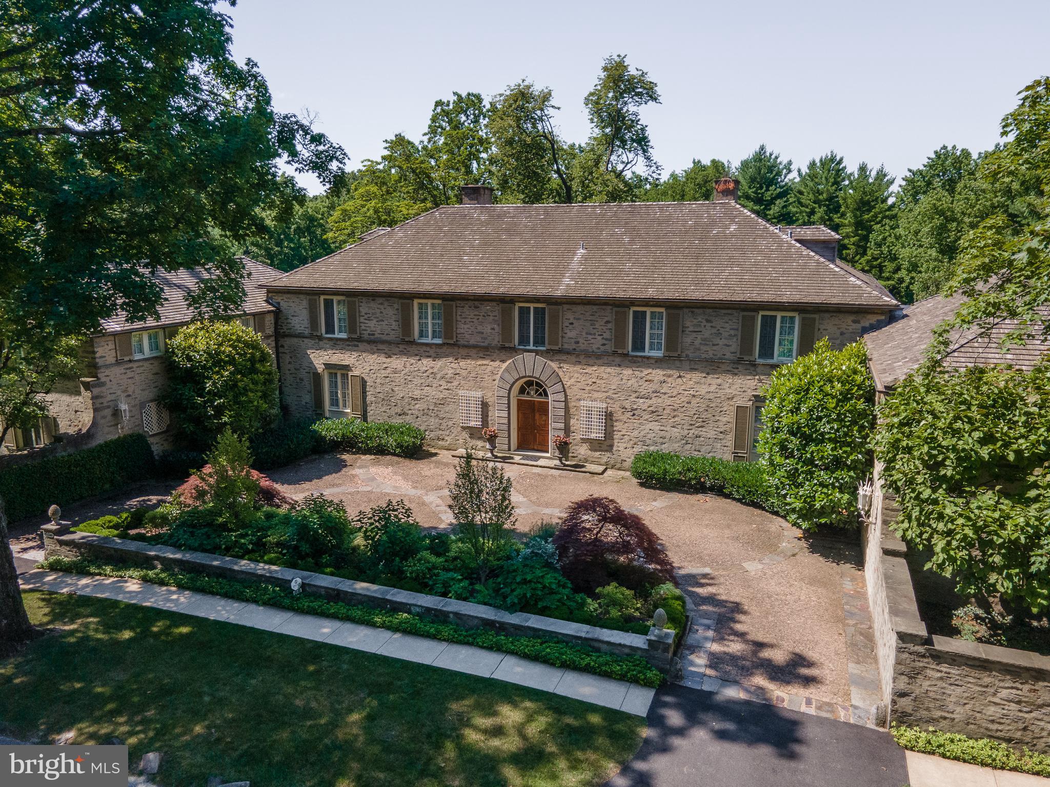 Presenting one of Chestnut Hill s premiere estates. La Primavera: the name evokes a light and happy aura spring. Robert McGoodwin s design for the idyllic site on the edge of the park reminds a viewer of an Italian hillside villa, but only when viewed from behind. From the street, a protected court shows only a discreet arched entry door and a simple rusticity with only a hint of Italian precedents. This Italianate country house sits on app3.28 acres of land with the most beautiful views of the Wissahickon Valley and Fairmount Park. With its tall trees and open tiered lawns, superbly built stone walls, multiple terraces and low maintenance planting it is an idyllic setting for any house. Meticulously maintained during their ownership, these Sellers are proud of keeping this property up to the standard that it deserves. The grounds, the trees, the pool, the tennis court, the cottage, and the systems have been painstakingly overseen over the years and it shows! This is in many ways a perfect sized house with two floors of living space, yet room for home office, storage, hobbies, and relaxation.The front cobblestone courtyard welcomes you with a newly refurbished landscape plan by Elise Geyelin. The double door entrance with arched window above opens to a lovely entrance hall with a limestone floor. The entrance to the grand formal Living Room with fireplace and three sets of French doors draw you to the spectacular green woodland view beyond. The first floor plan is balanced with a stunning Library with built-in bookshelves, fireplace, parquet floor and exquisite original detail. On the other side of the Living Room is a similar sized Dining Room, also with fireplace. Both of these rooms extend out to two separate Sun Porch Rooms which take in the dramatic views of Fairmount Park. There are all the additional spaces one needs for comfortable living including the powder room, large mud room, multiple closets, and Pantry with original glass cabinetry and every amenity which add to this perfect first floor layout. But the heart of the home is truly the Kitchen. With its four exposures, it is constantly filled with exceptional light and cheeriness from sunrise to sunset. Custom built cabinetry, granite counters, and every appliance possible including a Viking commercial six burner gas range with double ovens and hood, SubZero refrigerator/freezer, two sinks and additional wall ovens and microwave. All are in an open setting with a large comfortable Family Room. The layout of the first floor is perfect for small, medium and large scale dinner parties and entertaining. The house embraces entertaining with its intimate areas and flow.The second floor has five main bedrooms, two are suites with fireplaces, dressing rooms and their own bathrooms. All bedrooms have finished hardwood floors beneath the carpeting, summer doors and ceiling fans for warm summer nights. The Guest room wing which holds the fifth bedroom, also has a bathroom, sitting room and a laundry room. Over the garage is an apartment with a separate entrance with a Kitchen, Bedroom and Bath. Below the apartment is a three car heated garage. With two floors of generous sized rooms, the third floor has only attic storage, a cedar closet and air conditioning duct work. The basement has a finished Rec Room, a Ping Pong Room and unfinished areas of Potting/Plant room, Workshop, and storage. It is the perfect area for hobbies and gardening with easy walk out access to the outside. The grounds speak for themselves. They are immaculate and mirror the loveliness of the surrounding woods and Fairmount Park. It is hard to believe that all of this is within walking distance to the shops, galleries, farmer's market and restaurants of Chestnut Hill, as well as Fairmount Park and the train to Center City. There are very few places in the country that could offer this kind of convenience and comfortable style of living in such a luxurious setting.