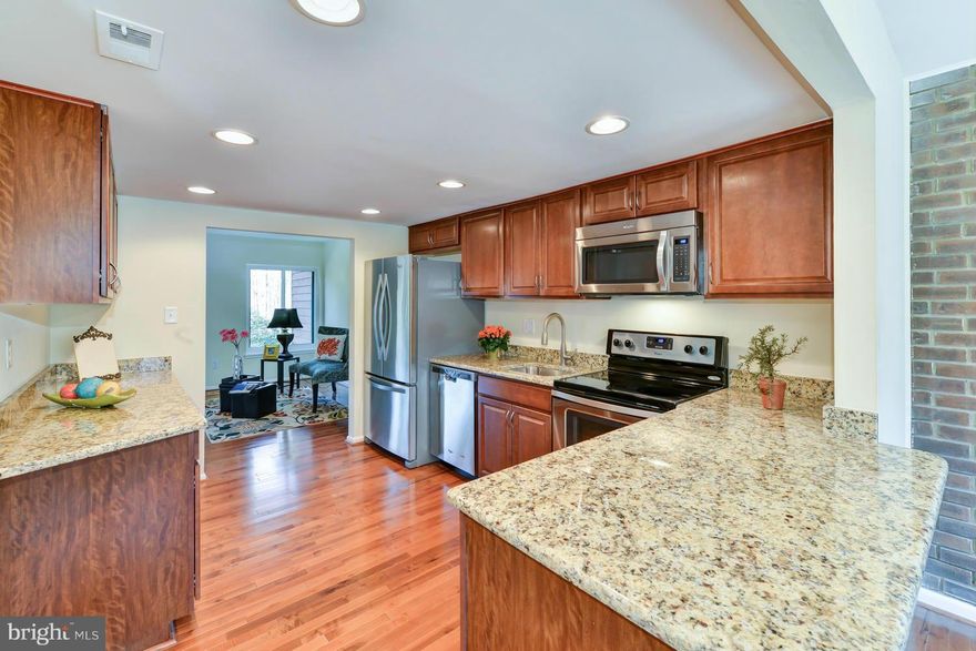 NESTLED BY NATURE AND NEWLY REMODELED ALL SINCE NOV 2014!  Spacious upgraded townhome backs to trees.  NEW kitchen w/ expanded cabinetry, Santa Cecilia granite counters and breakfast bar, stainless appliances w/ French-door fridge, recessed lighting.  ALL BATHS fully upgraded.  Gleaming new hardwoods throughout main level, brand NEW WINDOWS and sliding doors, new carpet, paint, and more! Gorgeous!