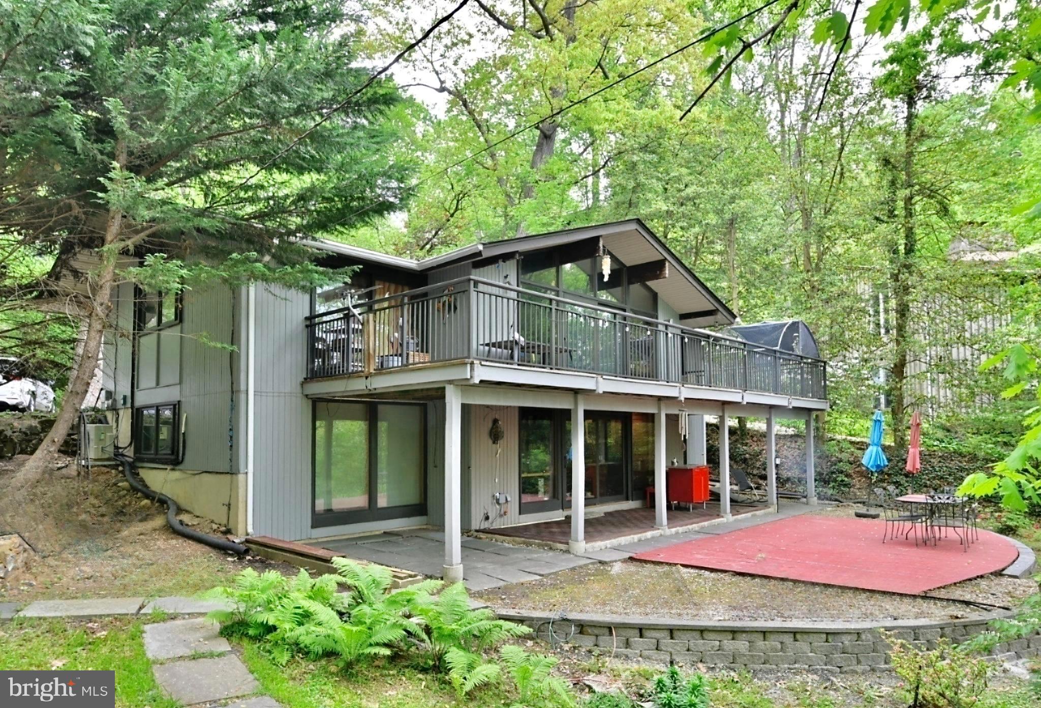 This thoroughly and comprehensively updated mid-century contemporary home boasts an above average lot size (approximately 0.6 acre) with mature trees providing privacy and acting as an effective noise shield. It's nested at an elevated position up on a hill with a private driveway and captivating seasonal views of Potomac River. The highly sought-after Glen Echo Heights is a quiet neighborhood oasis with a rustic feel that at the same time, offers driving proximity to D.C, the larger Bethesda area and Northern Virginia. The C&O canal park and neighborhood pool (with transferable membership) are both within a short walking distance.
This two-level dwelling possesses the unmistakable hallmarks of classic mid-century-style: cathedral ceilings, extra- large picture windows and open spaces. The house also features a spacious balcony/deck suitable for entertaining dozens of guests and providing serene views of the woods.
While carefully preserving the authentic look of the house, the owners have performed an array of improvements over the years, inside and out, among them: installed custom Pella wood frame windows, etched glass and/or mirror accented doors, replaced the roof (plus added modern insulation), re-insulated the walls, replaced two HVAC units and added a split AC/heat pump for bedrooms, as well as a tankless water heater; upgraded the electrical panel and installed a central vacuum. All kitchen and laundry appliances were also upgraded (full List of Improvements is in the Documents section of this listing).
Come see this gem of a house! It promises an opportunity to live in harmony with nature and modern living space in one of the region's most desirable enclaves.