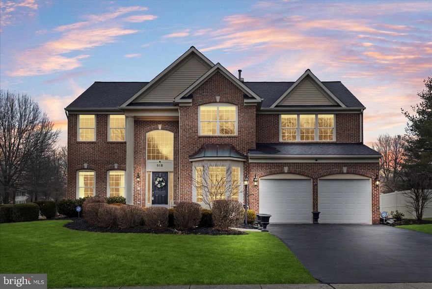 Welcome to 918 Forest Bay Court | Canter Farms – Phase II. Situated on a desirable corner lot within a quiet cul-de-sac, this former model home showcases timeless elegance, thoughtful updates, and meticulous care throughout. This beautiful brick Colonial offers approximately 4,248 finished square feet across three levels, featuring 4 bedrooms and 3.5 baths, with two additional flexible rooms in the finished basement ideal for a home office, gym, hobby space, or guest accommodations. Step inside to a dramatic two-story foyer, creating a grand first impression and filling the entry with natural light. The home also features 9-foot ceilings throughout the main level, enhancing the open and spacious feel. The main level was fully renovated in 2021, featuring luxury vinyl plank flooring, updated lighting, a redesigned fireplace, and a stunning gourmet kitchen with white and gray cabinetry, quartz countertops, stainless steel appliances, pantry, beverage center, and upper cabinet accent lighting. A sunroom bump-out with two skylights fills the space with natural light, creating a bright and inviting atmosphere. The main level also includes a private office with built-ins. The spacious primary suite offers a tray ceiling, a double-sided gas fireplace, a sitting area currently used as a second office, a walk-in closet, and an ensuite bath with soaking tub and skylight. The upper-level hall bath was updated in 2023. The finished lower level expands the home’s living space with a full updated bath, bar/kitchenette area with porcelain tile, flexible recreation space, and generous storage. Outdoor living is equally impressive. In 2024, a luxury screened-in porch was added featuring a cathedral ceiling, Trex decking, skylights, recessed lighting, and a separate electrical breaker. A new stamped concrete patio (2024) creates the perfect setting for outdoor entertaining. Additional updates include a 30-year architectural roof (2018), dual-zoned HVAC (2018 & 2006), garage doors (2022), interior paint (2021), and an irrigation system to maintain the beautifully landscaped yard. 
Conveniently located near shopping, restaurants, and major commuter routes including Fort Meade, NSA, MARC, DC, Baltimore, BWI, and Annapolis, this home offers a perfect blend of luxury, comfort, and convenience. Schedule your private tour to experience the scale, elegance, and thoughtful updates firsthand!