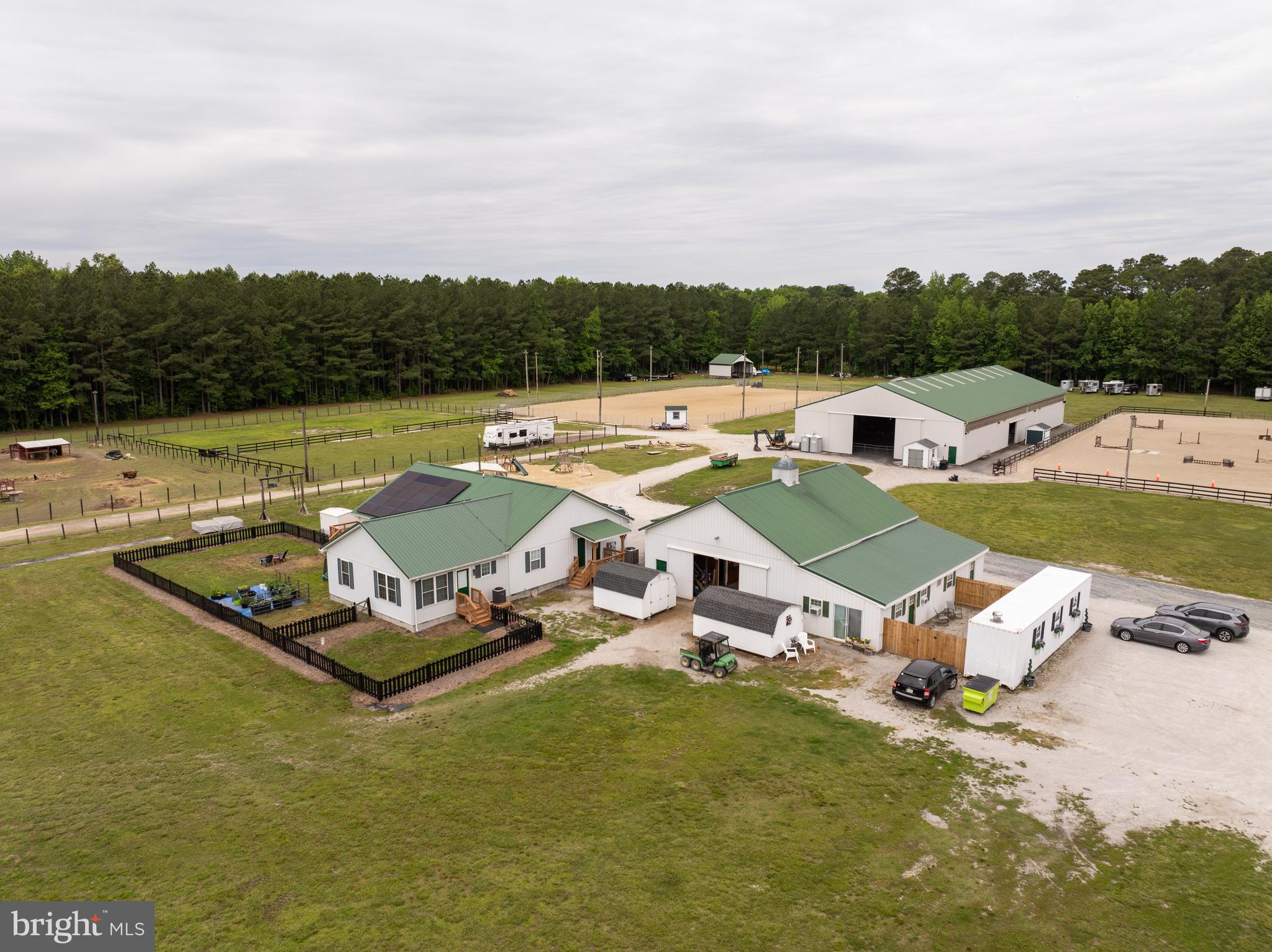 Introducing Kindred Spirit Farm - one of the Eastern Shore’s foremost horse farms, encompassing over 50 acres of meticulously tended horse amenities. The property boasts an Indoor Arena (70' x 160') currently used for indoor training during inclement weather, wooden stalls, temporary stalls which can be removed or reconfigured for a round pen, and hay/grain storage. There is an English Arena (150' x 250') renovated in 2021, enclosed with 3-rail black, wooden fence with a full course of jump standards with poles and gates. Also, a new Western Arena (150' x 250') built in 2022 large enough to run a regulation size NBHA barrel pattern and a pole bending pattern. Both arenas have a sound system, lights inside and outside the rings, and a judges/announcers shed with plenty of parking for horse trailers at events as well as for boarders. Next to the Western Ring is a fenced dry lot (164' x 98'), a list (175' x 8') which was constructed for lessons, to do jousting and mounted archery, and a waiting area for events (164' x 78'). The two-story barn (48' x 32') has four wooden stalls with metal bars, two have rubber mats, two have stone dust base with removable wall to be used as a foaling stall. Barn includes two tack rooms and a grooming area as well as two more bonus rooms. There are also 23+/- acres of new pastures and paddocks fenced using 3-rail fence with horse safety electric on top rail, automatic waterers, electric and lights, two run-ins, another 4-stall barn (26' x 28') with removable walls for reconfiguration. Additional amenities include dry lots, playground, camp room, horse trails, shooting range, garage, riding trails, and more. The farm is fully equipped to host lessons, boarders, English shows, Western shows, barrel racing, IEA team events, camps, and much more.
There is a 2,544 sq ft renovated ranch-style, handicap-accessible home with three bedrooms and 3.5 baths. Surrounded by expansive decking on two sides is the open concept kitchen and living room with cathedral ceilings for a light, airy feeling. Directly off the living room is the newly renovated primary bedroom with three closets and an ensuite bathroom that includes a large soaking tub and walk-in shower with rainfall showerhead. Down a private hallway off the kitchen is a second bedroom with two closets, full bath remodeled in 2025, and a multi-purpose bonus room. Renovations also include a brand new HVAC installed in 2025. The house includes an apartment-style addition with private entry built five years ago that includes a bedroom, full bath, kitchen, and family room. There is also an entry into the mudroom with commercial washer and dryer from the direction of the barn and a private half bath accessible from outside the house for barn use. Please see their Facebook page at Kindred Spirit Farm, LLC additional pictures and information.
Please see additional pictures and property details included with the listing.
Private tours are available to verified, pre-qualified buyers.
