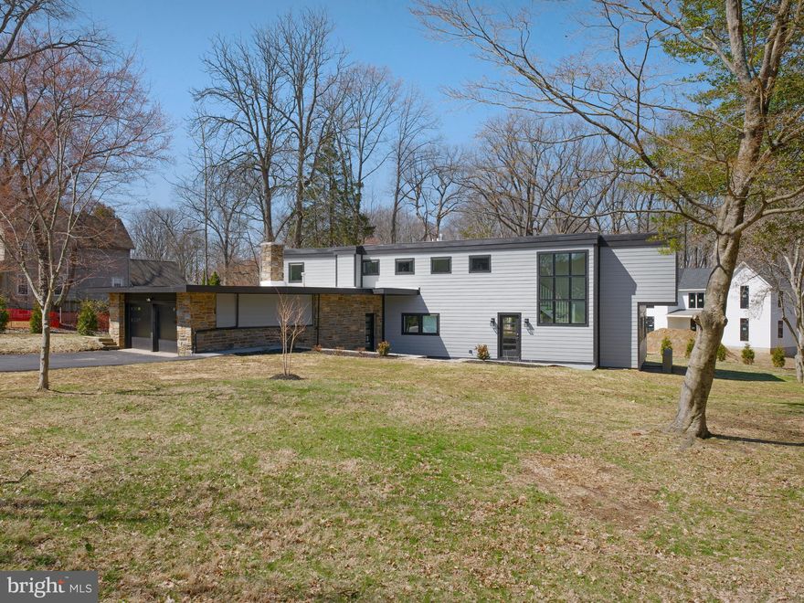 Fully renovated mid-century contemporary set on more than half an acre of landscaped grounds just minutes from the heart of Media Borough.

Approached through a stone-walled garden courtyard, the home opens to bright interiors defined by clean lines, expansive windows, and open living spaces filled with natural light.

The main living level offers a seamless flow between the kitchen, dining area, and living room. The kitchen is designed with warm wood cabinetry, quartz countertops, stainless steel appliances, gas cooking, and a large center island with seating. Walls of windows bring natural light into the adjoining living spaces while overlooking the surrounding property.

A separate den provides flexibility for a home office, library, or additional sitting room.

The upper level includes four bedrooms, highlighted by a primary suite with a private bath and a spacious walk-in closet. Several bedrooms reflect the distinctive geometry characteristic of mid-century architecture. A conveniently located laundry room completes this level.

The finished lower level expands the home’s living space and offers flexibility for recreation, fitness, media, or play, with walk-up access to the rear grounds.

Outside, the half-acre property provides generous space for outdoor living. A newly constructed deck extends the interior living areas outdoors and overlooks the level yard.

Located within the Rose Tree Media School District and close to Media Borough’s restaurants, shops, and community events, with convenient access to Route 252, Route 1, Route 476, and I-95