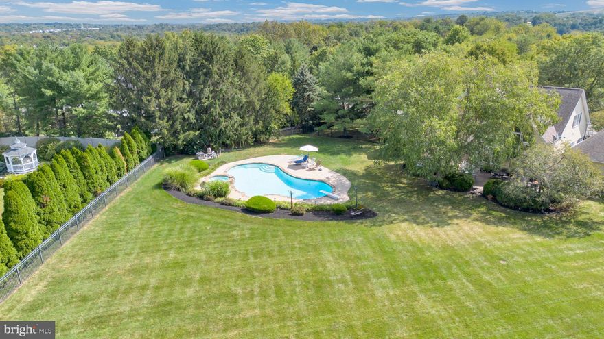 If you are seeking a backyard oasis, you have to walk this property.  This exceptional residence presents a seamless blend of luxury, advanced technology, and versatile living—all perfectly situated just moments from premier shopping and major routes, including Route 422. Located within the highly sought-after Spring-Ford School District, this distinguished home was originally the community’s model, offering an impressive array of premium upgrades throughout.
From the moment you enter, you’ll appreciate the exquisite craftsmanship, highlighted by a Premium Wood Trim Package, a fully integrated ELAN whole-home audio system, comprehensive security system, and sophisticated whole-home lighting controls. Thoughtfully designed built-in cabinetry enhances both the study and office, while a stylish wet bar and a dramatic wall of windows elevate the inviting Family Room. A Tesla Wall Charger in detached garage adds modern convenience, and a private studio with its own entrance and HVAC system offers exceptional flexibility.
Spanning three beautifully finished levels, the home offers 4 spacious bedrooms and 5 full baths, designed to accommodate both everyday living and elegant entertaining. The gourmet Kitchen features an extended peninsula island with granite countertops, opening to a breathtaking two-story Family Room with a secondary staircase. Formal Living and Dining Rooms provide the perfect setting for hosting, while a first-floor office and laundry add everyday ease. The fully finished lower level is an entertainer’s dream, complete with a two-tier media room, gaming area, and an additional study accented by rich cherry shelving.
Step outside to your own private retreat—a resort-style oasis featuring a sparkling in-ground pool, expansive deck with gazebo, paver patio, and a fully fenced yard set on nearly an acre of level, usable land.
More than a must-see, this is a must-experience home. Schedule your private showing today—and be prepared to fall in love.