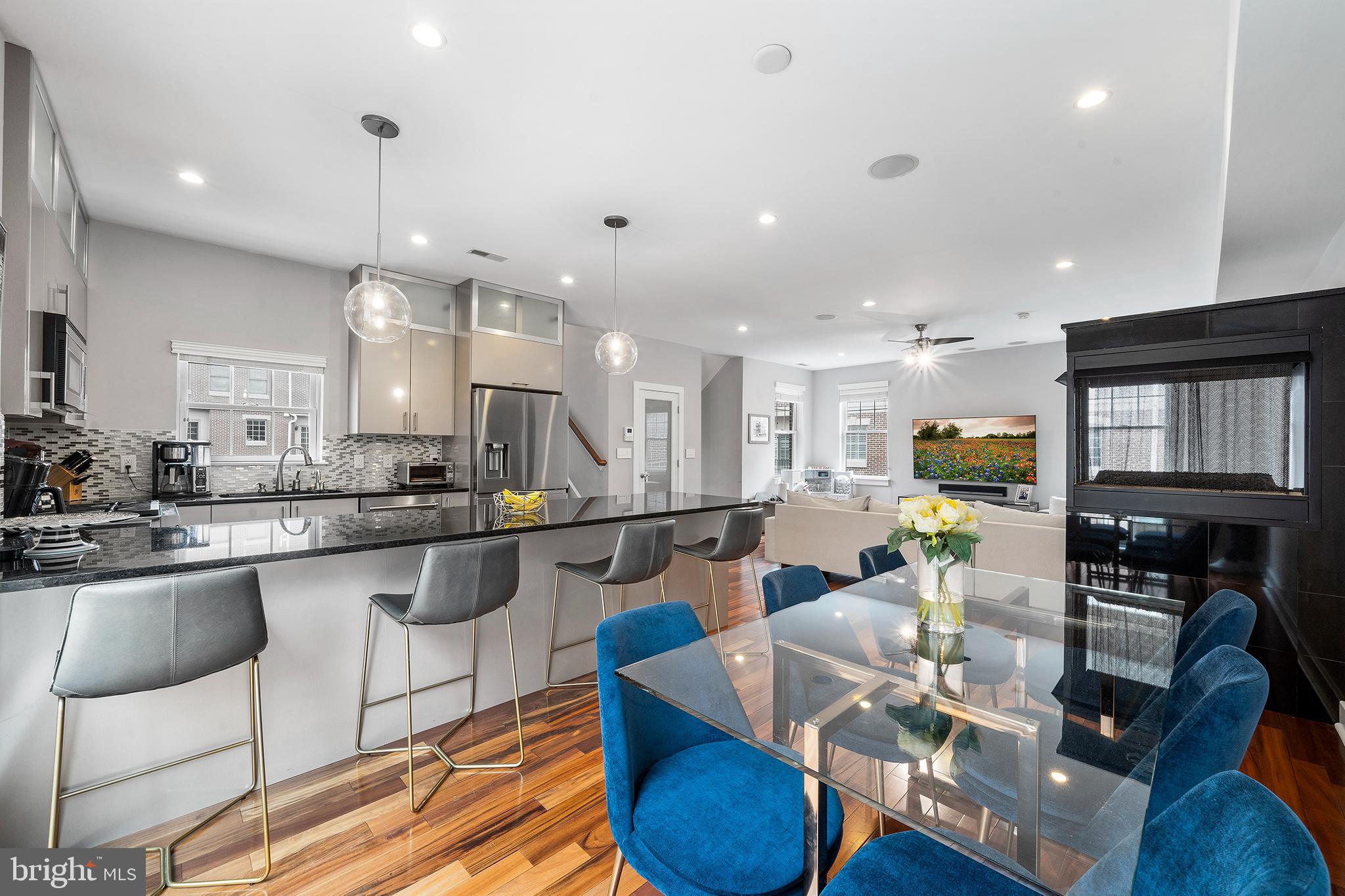 Welcome to this bright and sophisticated 3-bedroom, 3.5-bath home—the largest and most desirable model in the sought-after Independence Court community. Tucked away in a private courtyard setting, this fully upgraded, move-in-ready property offers the perfect combination of space, style, and comfort. The open-concept main level features Brazilian hardwood floors, an oversized living room with a three-sided gas fireplace, a separate dining area, and a beautifully upgraded kitchen complete with granite countertops, glass tile backsplash, a large island (seating four), high-end appliances, a U-line wine cooler, and sliding doors to a Juliet balcony. Upstairs, you’ll find two generous bedrooms, two full baths, and a convenient laundry room. The top level is dedicated to an expansive primary suite, featuring abundant storage, custom John Louis closets, and a luxurious en-suite bath with a Jacuzzi soaking tub and a large custom shower. This unique floor plan also includes a first-floor den, a finished basement, and premium upgrades. Enjoy natural light from three exposures and the convenience of a full-sized garage that fits an SUV with ease. Located in the Meredith School Catchment, this home offers the best of both worlds—peaceful community living with close proximity to the city’s best restaurants, coffee shops, markets, parks, and playgrounds. Easy access to public transit, major highways, and commuter routes makes this home a rare find in Queen Village.