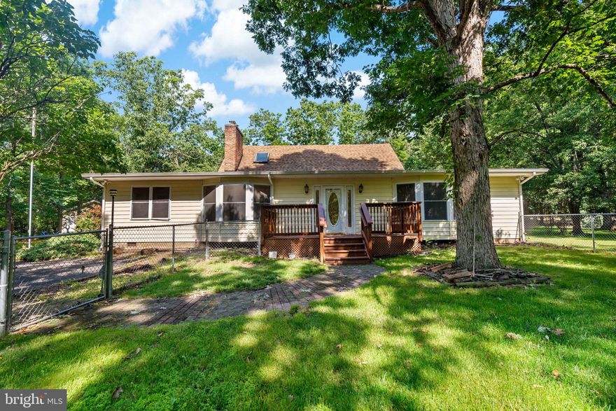 Welcome to your new home! Peace comes rapidly as you drive down the long paved driveway from all the hustle and bustle of everyday life in this fast-paced world. When you come down the driveway alone, you can start to breathe a sigh of relief as you go through the trees in this wonderful small community of homes with large amounts of acreage. This particular home has over 7.5 acres, 3 bedrooms, 3 full bathrooms, with an additional room that could be a bedroom or an office on the first floor by the primary bedroom. You have plenty of space in the main area of the home with the kitchen which includes a moveable island, dining room, large living room, and sitting room with a fireplace. This home consists of 3 floors with the primary bedroom on the 1st floor, the 2nd floor has 2 more bedrooms with additional AC units in windows for added coolness upstairs and another bathroom, and a basement that could be a media room, exercise room or anything else you'd want to do to make it your own. The wood stove, fireplace and hearth make the home warm and cozy in the cold months too. The land has a little stream running through it, and deer troughs so that you can feed the deer, watch the birds, and see all kinds of beautiful nature and wildlife. For all you car buffs there are 4 garage spaces plus a carport for an RV or a boat! Only 15 minutes to the train station, shopping, dining, commuter routes, and more! Come check out this new house on the market and envision this as your new home. Photos by SC Studios!