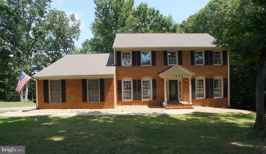 Stately Brick Front Colonial on RARE 1+ Acre Lot is Spacious, Bright and Move In Ready!  Many Features Including: *Side Load 2- Car Garage w/Lvl Concrete Driveway *1.05 Acre Corner Lot with Room For Pool, Playground, Shed, etc *Open Kitchen w/Granite Counters, Breakfast Bar, Octagonal Box Ceiling & Ceramic Tile Backsplash *2-Piece Crown Mldg & 2-Piece Chair Rail *Hardwood Floors throughout majority of Main Level *Family Room w/Vaulted Ceiling, Twin Skylights, Built In Bookcases & Wood Burning Fireplace with Gas Log Insert *Security System *Trane Heat Pump w/Humidifier & Electronic Air Filter *Huge 1400+ sqft Unfinished, Walkout Basement with Egress Windows **Less than 1 Minute to the Residents Only Rear Gate** *Abundant Community Amenities including Security Gate, Police Force, Rescue Squad, Marina with Boat Ramp, Golf Course with Driving Range and Putting Green, Stables, 2 Pools, Dog Park, Restaurant, Tennis, Basketball and Much More!