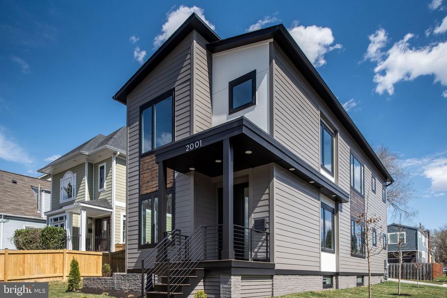 Currently occupied, Available Jan 1,2026 for flexible short term lease of 30 days to 6 months or month to month.  Price listed is unfurnished and utilities paid by tenant. A one of It's kind new construction contemporary custom home by The Zelaya Homes Team! This three-level home features 6 bedrooms, 4.5 bathrooms, and 3,402 total finished sq. ft. (2,268 sq. ft. above grade + 1,134 sq. ft. finished basement) and a 240 sqft detached garage. Situated on a level, corner lot, this home enjoys abundant natural light throughout the day, making every space feel open and inviting. The main level features an open-concept layout, where the spacious family room features a remote-controlled gas fireplace. The beautifully designed kitchen includes an oversized quartz island with seating for 8. A Thor 36" gas range with built-in air fryer, an LG smart refrigerator with four types of craft ice, a microwave drawer, a mini beverage fridge with dual temperature zones, and under & over cabinet lighting for a refined ambiance. A walk-in pantry and extensive cabinetry offer plenty of storage, ensuring both style and functionality. The main level bedroom, offers privacy for guests or a personal home office with convenience to the powder room. Adjacent to the kitchen, the mudroom offers a drop zone for a seamless transition from the detached garage, which includes an EV-ready 40-amp plug and a quiet door opener. Stepping outside, the stone paver patio and backyard offer a tranquil space for relaxation, entertaining, or even expanding into an outdoor kitchen, thanks to the pre-installed natural gas connection. The second level of the home features four bedrooms and three full bathrooms The primary suite showcases a spa shower with dual rain shower heads, double vanity, a private water closet, and a large walk-in closet. The Laundry room is located adjacent. The finished basement expands the home’s living space with a large recreation room, a wet bar with sink and beverage refrigerator, an additional bedroom and full bathroom, large storage closet, plus a separate walkout entrance, making it an excellent option for guests, extended family, or rental unit potential as a separate ADU. Throughout the home, attention to detail is evident, with 9’ ceilings on all levels, wide-plank engineered hardwood floors, and energy-efficient LED lighting with dimmers. All closets have interior lights. The home is equipped with dual-zone HVAC with wi-fi thermostats, LED light fixtures through out, a tankless water heater for on-demand hot water, and a sump pump & French drain system. Located in the desirable Highview Park neighborhood of North Arlington, this home is just minutes from Virginia Hospital Center, Ballston Quarter, Clarendon, and Virginia Square, offering incredible dining, shopping, and entertainment options. It is also close to top-rated Arlington schools, parks, and major commuter routes, including I-66, Route 29, and Metro stations, providing an easy commute to Downtown DC, The Pentagon, Amazon HQ2, and Reagan National Airport. This exceptional home combines modern elegance, smart living, and a prime location. Don’t miss this opportunity—schedule your private tour today!