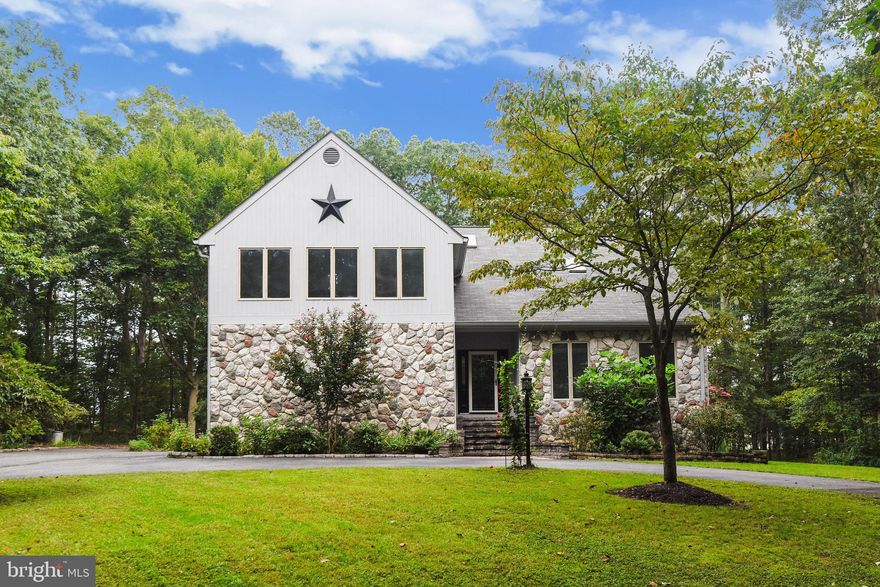 Stunning, custom-built home nestled on a private lot backing to trees.  Open main level with welcoming two story foyer, a two story grande gourmet kitchen featuring quarzite counterops, custom shelving, sliding shelving in cabinets, stainless steel appliances and large kitchen island.  Large family room off of eat-in kitchen with stacked stone gas fireplace and engineered hardwood flooring.  Spacious and open dining and living room with gas fireplace, ample space for entertaining.  Upper floor features a primary suite with ensuite bath, walk-in close, and second closet with custom built-ins.  Two additional bedrooms that face the beautifully landscaped front yard.  Second bath services additional bedrooms and lovely loft room with balcony over kitchen and living room.  The deck off the kitchen serves as a wonderful place to dine, entertain, relax in the hot tub and enjoy the peaceful wooded lot.  Numerous recent updates include:  main level hybrid Hvac system, upper level Hvac system, tankless water heater, upper level carpet, exterior freshly painted including deck. Lush, vibrant  landscape surrounds this beautiful home.  Live in a serene setting, with close proximity to all commuter routes!  Only 17min from the Woodrow Wilson Bridge!  Close to parks, farm stands and major shopping. Please see: https://tour.truplace.com/property/2232/90618/