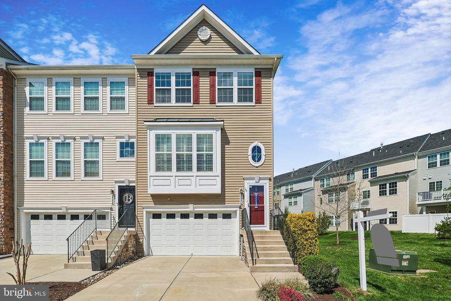 Welcome to effortless luxury in the highly sought-after Villaggio Enclave. This stunning 2016 end-unit townhome offers a bright, open-concept design accented by rich wood floors and recessed lighting. Entertain with ease in the spacious chef’s kitchen, featuring a massive prep island that connects directly to the welcoming family room. Downstairs, a fully finished lower level provides versatile bonus space to suit your needs. Upstairs, you'll find the convenience of bedroom-level laundry alongside a tranquil primary suite . Outdoor living is a dream: host dinners on your private deck overlooking serene, tree-lined back yard and side yard open space, or relax on the patio below. Thanks to an integrated under-deck drainage system, the lower patio stays  dry, allowing you to enjoy the outdoors even on rainy days. Complete with a two-car garage, this property offers an elegant, low-maintenance lifestyle.