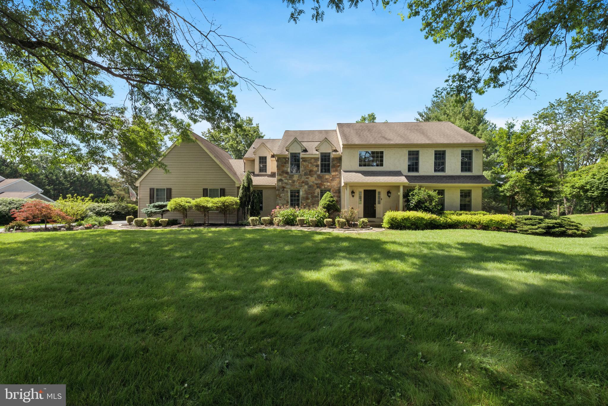 This exquisite West Chester colonial home displays a captivating curb appeal, surrounded by a verdant, one acre+ lot, and situated on a quiet Cul-de-sac. The center section of the front facade is graced with two stories of fieldstone, flanked by Hardi-Plank siding and stucco, while the landscape of mature shrubbery and towering trees (beautifully lit at night) adds to the irresistible charm of the home. The level rear yard overlooks a 50 acre conservation preserve, thus insuring wooded privacy. Relaxing on either the open deck or the screened porch (accessed from the Breakfast Room) and enjoying the family of deer who venture onto the grass, is a favorite pastime of the owners. The interior tour begins once inside the attractive front door; a soaring two-story Foyer divides the formal Living and Dining Rooms, both with classic dark-stained hardwood floors. The Dining Room also features crown and chair molding. At the rear of the home, find the spacious Family Room (hardwoods, stone Fireplace, wet bar), and French doors leading to the dedicated Home Office. A chef's delight is the French Country-style gourmet Kitchen, embellished with granite countertops, built-in microwave and oven, glass cooktop, an abundance of KraftMaid cabinetry including buffet bar, and generous workspace, including both a Breakfast Bar as well as the adjoining Breakfast Room. The entire Main Level displays hardwood floors, including the Kitchen and Breakfast Room. Completing the first floor is a convenient Powder Room, plus Laundry Room/Mud Room (with spacious pantry closet. Added touches are the plantation blinds on most windows; all Baths have new lighting and plumbing fixtures, too!The turned hardwood staircase leads to the second floor where brand new random width hardwood flooring can be found in the gallery hall. Four well-proportioned Bedrooms await (all with ceiling fans for added comfort). The primary Suite offers the same new random width hardwood floors, a walk-in closet with barn door, and a gorgeous Primary Bath with marble tile, jetted tub, and walk-in marble shower with frameless glass door. The spacious Hall Bath displays a double vanity with Corian counter, and tub/shower combination. Not to be missed is the fabulous finished Basement - just the perfect spot for family relaxation or entertaining. The Great Room/Media Room offers space for everyone, and sliders to the hot tub (included and still under warranty. A custom built-in granite counter Bar is a wonderful addition to this space. An additional room -- currently utilized as a hobby area - could also function as an additional Office, or Gym. There's even a Powder Room on this level, with adjacent space to add a shower, plus an amazing amount of storage in the unfinished room and multiple closets. The yard beyond includes an 18x12 garden Shed, with electric service, perfect for storing gardening equipment or working on those outdoor projects. An addition feature here is the invisible fence, including dog collar, controls, and a component that permits in-home usage; you can keep your pup out of restricted rooms. As a reminder, this summer heat will give way to winter storms; the whole house generator has you covered. In 2013, Nolen Builders completed an extensive renovation which included new windows, Hardi-Plank siding and new stucco. Adding to the appeal of this home and location are the award winning West Chester schools (districted to Rustin High School), and close proximity to downtown West Chester, the Amish Market, restaurants, shopping and major highways. As the first listing in Radley Run IV in nearly a year, 1007 Regimental Drive is worth the wait.