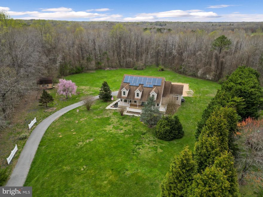 Exquisite Cape Cod Retreat:  Discover luxury living in this stunning Cape Cod home nestled on 4.69 acres of picturesque land in serene Calvert County, Maryland.  As you approach, you'll be greeted by a paved driveway, providing seamless access to every corner of your domain. One of the standout features of this property is the convenience of electric access along the entire length of the driveway. Whether you're arriving home after a long day's work or hosting guests for a weekend getaway, the ease of electric access ensures that your every need is met effortlessly.  As you explore further, you'll discover a spacious barn, complete with electricity. Perfect for hobbyists, animal enthusiasts, or those seeking additional storage space, the barn offers endless possibilities. Imagine transforming it into a workshop, studio, or even a charming venue for gatherings with friends and family.  So much to do here, with ample space to roam and explore. The owners actually designed this home, and the home boasts 4 bedrooms, including a main floor primary bedroom for added convenience and comfort.  Indulge in the luxury of 2 and a half baths, featuring premium fixtures and finishes.  The heart of the home, is in the spacious eat-in kitchen, this is a chef's delight, equipped with gas cooking, convection oven, microwave,  dual dishwashers, trash compactor and adorned with luxury vinyl tile flooring. Bask in natural light and panoramic views while working from home in you home office.  Then step outside to your Brazilian wood deck overlooking the sprawling backyard, ideal for al fresco dining and gatherings, entertaining guests, or just to relax.  Oversized 4-car garage complete with a workshop area, there's plenty of space for vehicles, hobbies, and storage.  You can access the upper and lower levels from the main level via your elevator, for that added convenience.  Enjoy the tranquility of your surroundings from the inviting front porch, complete with a soothing koi pond. Experience the freedom of well water and septic system, eliminating monthly water bills and offering environmental sustainability.  Additional barn toward the front of the property. Embrace the freedom of no homeowner's association, allowing you to personalize and enjoy your property without restrictions. Conveniently located in Calvert County, Maryland, enjoy easy access to local amenities, schools, parks, and more. Don't miss this rare opportunity to own your own slice of paradise in Calvert County.  Schedule your showing today and make this dream home yours!