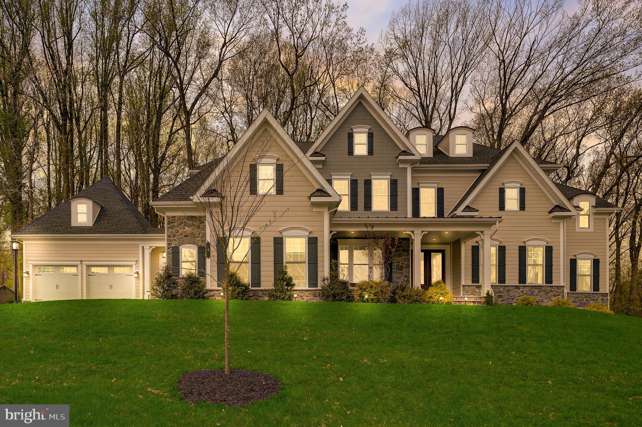 Every once in a while, a one of a kind property comes to the market and that time is now! Welcome to 6 Gershwin Dr, in the desirable Greystone community. This is the first available resale opportunity in the Estates at Greystone. Built in 2021, this supersized Clifton Park II boasts over 8,600 sq ft! Driving in, you will immediately notice this stately residence stands tall, high above the street on a premium homesite. As you approach, take notice of the conservatory, expanded covered front porch, and 4-car garage. These structural options are a rare find! A double glass door entry welcomes you into the home, where you will be greeted by a grand 2-story foyer with a stunning waterfall staircase. A brilliant floor plan awaits inside that perfectly blends traditional design with every accommodation for today’s lifestyle. The main level is highlighted by the kitchen, family room, and conservatory. The dream kitchen was built for a chef. It features high-end cabinetry with glass and light accents, soft close drawers & doors, 2 massive islands, prep sink, quartz counters, tile backsplash, 5-burner gas cooking, vented hood, double oven, 2 dishwashers, 2 wine coolers, beverage fridge, and walk in pantry! The kitchen opens directly to the bright breakfast area and dramatic 2-story family room. The family room offers a wall of windows, built in cabinetry, coffered ceiling and gas fireplace. The conservatory off the living room is a game changer. With the added windows, it is a bright space with many uses. A formal dining room, office, laundry, powder and mudroom complete this level. The upper level is highlighted by the primary bedroom suite. This generously sized bedroom features a tray ceiling with crown molding, sitting room with entry to private balcony, and a deep and wide walk-in closet. The primary bathroom feels like an at home spa with an oversized tile surround shower with bench and double head, soaking tub, double vanity and separate water closet. This level is completed by 4 additional bedrooms, each with their own private full bathrooms, and a second laundry room for convenience. Need more space? The lower level provides over 2,300 sq ft of lavish living space. There is a theater room, living area, full service bar, additional bedroom, full bath, gym, multiple storage areas and outside access. Looking for outdoor living space? The custom deck is over 800 sq ft with lighted posts and steps to the flat and usable yard. Need more value? The taxes were successfully appealed, the home is energy efficient with 5 zones, and it is ready for immediate occupancy! All of this in the most convenient location with quick access to routes 322, 202, 3, 30, and many more, so you can get anywhere fast! By foot, you can explore over 7 miles of scenic walking trails within the Greystone community and the Robert E Lambert park. Also within walking distance is Greystone Elementary. Within a short drive, is vibrant West Chester Borough and shopping galore in Exton! You must see it in person to fully appreciate the incredible value this special property offers. Schedule your tour today!