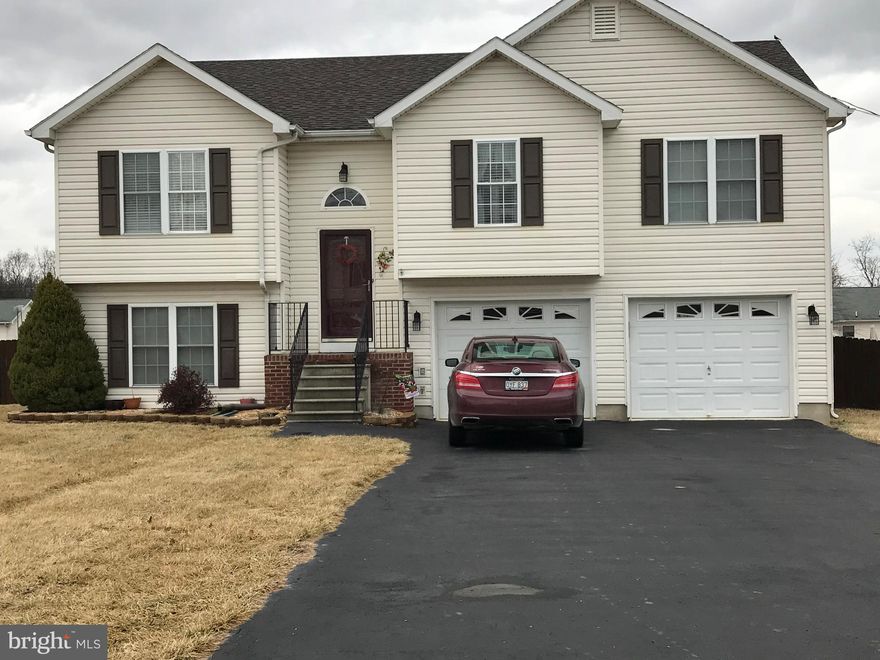 Lots of space in this 4 bedroom 3 bath home! Open floor plan with hardwood floors on main level. All appliances convey! Lower level bedroom and full bath with whirlpool tub. Family room has gas fireplace and sitting room also on lower level. HUGE 2 car attached garage with built in cabinets. Level backyard is fully fenced with privacy fence. Enjoy barbecues on the back deck or the concrete patio.