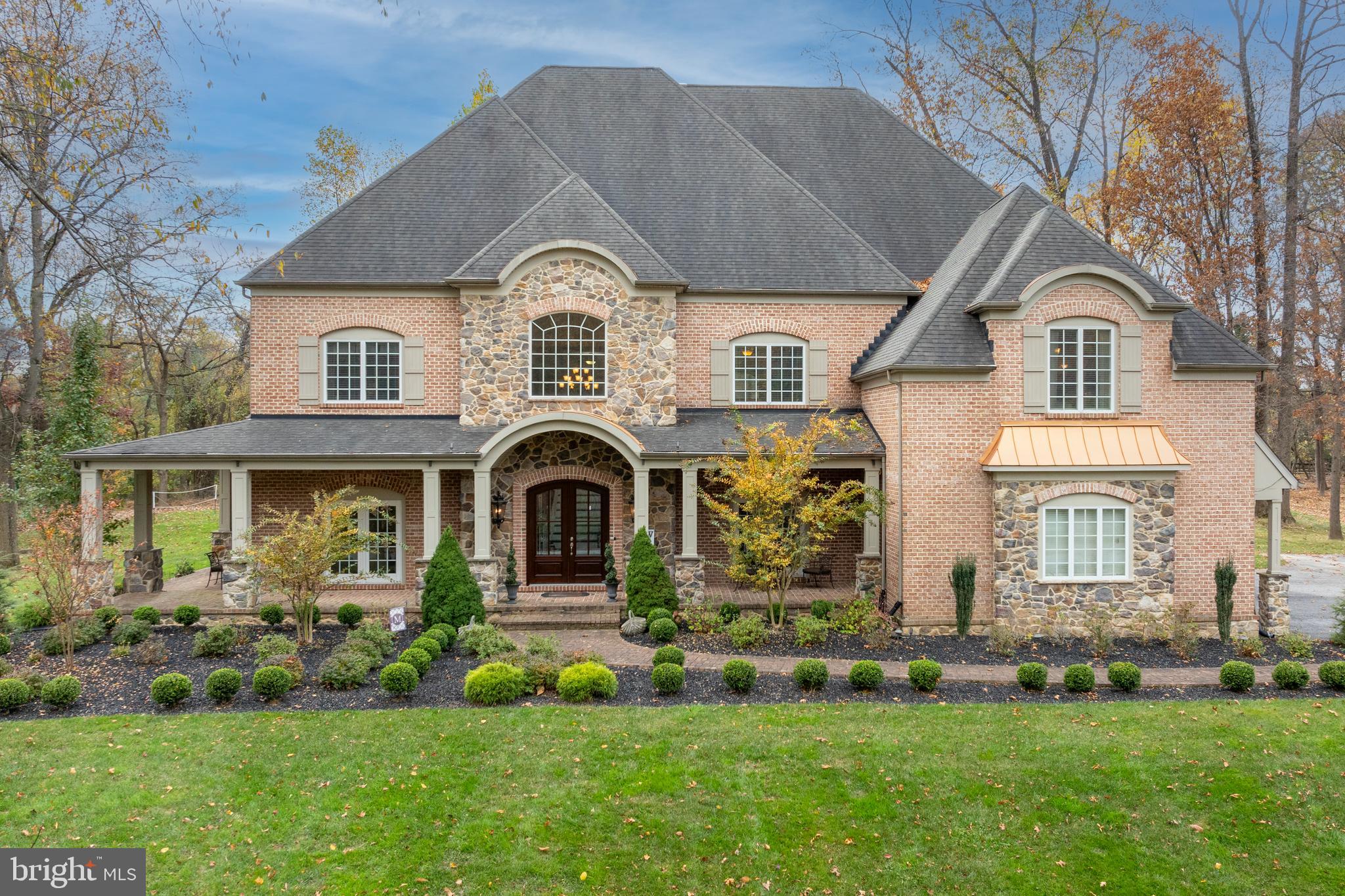 Welcome to this extraordinary home in the prestigious community of Medford. With almost 11,000 square feet of finished space, a property of this size and quality rarely comes to market. From the moment you cross the threshold you will be awed by the home’s light and space. Welcome guests into your grand 2-story foyer with its soaring staircase and impressive moldings. The well-appointed formal dining room opens from the foyer on the right, while the lovely formal living room is opposite. A luxurious wet bar with custom cabinetry connects the formal dining room to the gourmet kitchen. The kitchen is a cook’s dream, with its 48” Bertazzoni 6-burner (plus grill) range, Viking Professional refrigerator, beautiful stone countertops, loads of storage, and views to the landscaped rear yard. Adjacent to the kitchen is one of the home’s two large laundry rooms, this one with access to the 3-car garage – every detail of this plan was considered. A large eating area is off of the kitchen, with a wall of windows across the back of the house overlooking the stone patio and outdoor living room with fireplace. The huge yet comfortable double height family room with its built-ins and soaring stone gas fireplace opens to the kitchen, making it a wonderful room for entertaining while preparing meals. The spacious main floor also features a handsome office with built-ins, and a large billiard room with wet bar. Enjoy your backyard paradise with its huge, landscaped flat yard. So many outdoor entertaining spaces to enjoy! Covered porches, open stone patios and an outdoor living room with fireplace and television provide multiple options for entertaining or just enjoying your morning coffee. When weather sends you inside, there is much more for enjoying family and friends time on the lower level, which is like none you have ever experienced. Treat your guests to a movie or the game in your spectacular movie theater with its Dolby Atmos system and 150” screen. Also on the lower level are a large gym, a HUGE sports room that is currently outfitted for the soccer player in your life but could be used for any type of sport, a guest suite with a large walk-in closet and en suite luxury bath. The family room is the perfect spot to entertain or sit and relax, and there are numerous storage closets and play areas that complete this incomparable lower level. At the end of an evening, your primary suite awaits. This luxurious retreat features an enormous bedroom, his and her walk-in closets that are beyond compare, beautiful bathroom with spa tub and shower, his and her sinks. A coffee/wine bar and direct access to the sun porch with its cozy gas fireplace completes your oasis. Three other huge bedrooms, all with en suite baths and walk-in closets, and a large laundry room are featured on the second level. Every possible luxury and convenience has been designed into this extraordinary home. Be sure to watch the video of this superb home!