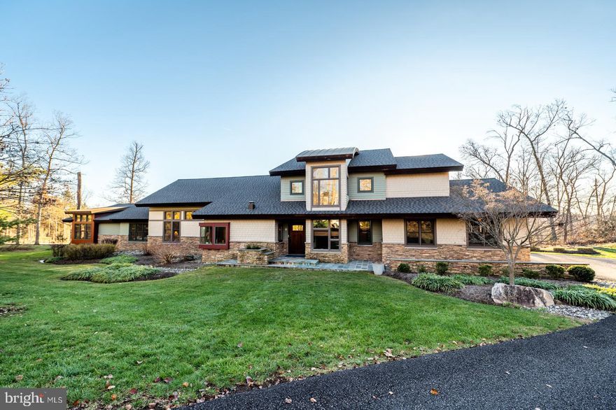 This one-of-a-kind craftsman style home was built in 2006 by the renowned architect Phillip D. Kunz and featured in architectural books and magazines. It was crafted from a curated selection of natural materials that articulate the structure both inside and out. From the walking path to the front door and throughout the entire home, the materials chosen reflect the serenity and oneness with nature. The immediate views when entering are awe-inspiring and like no other. The interior of the home features a contiguous open living area with an expansive cathedral ceiling that encompasses the living, dining, and kitchen areas. The living area is detailed throughout with American cherry, steel and copper collar ties with integrated ceiling fans overhead, and low voltage cable lighting chasing across the space. A free standing bar with wine cooler, granite countertop, sink, and seating is perfect for entertaining. The intimate dining area is delineated by a suspended custom-made lattice and lighting element constructed of American cherry and copper as well as slate flooring. The kitchen has exposed beams from which maple cabinets are suspended using stainless steel panels and lighting that is height adjustable. In addition, top of the line appliances, including a 6 burner gas Viking cook top and dedicated wok station, make this dream gourmet kitchen. Adjacent to the dining area is an additional family room defined by a step up as well as a custom American cherry cabinet that houses the media equipment hidden behind a series of doors in a chasing pattern. The media cabinet transitions at the ceiling by way of willow branch panels that create a veil of light. The gas fireplace hearth is comprised of two massive pieces of Pennsylvania blue stone with a thermal finish and the surround is made up of individual pieces of pin mounted slate. This elevated family room opens to the home office which is flanked by two sets of corner windows, providing for a tranquil work space and closes with double sliding doors. In 2014, Kunz designed an addition which houses 3 ample sized sunshine filled bedrooms, each with custom outfitted walk-in closets, and are connected by a hallway flanked by closets on either side. There is a hall bathroom with double sinks, a tub, and walk-in shower. The inground indoor endless heated exercise pool was completely renovated in 2022. A powder room, main floor laundry and oversized 3 car garage complete the main floor. Climb the exquisite open staircase to the second floor which boasts the owner’s suite featuring a center cut cedar ceiling, slate clad fireplace with unique copper flue and a balcony overlooking the main floor living space with double sliding doors. The en-suite bathroom was renovated in 2018 and offers 2 sinks, a double shower with Hansgrohe fixtures, and a separate room with a toilet, bidet, and additional sink. There is an incredible and spacious walk- through closet beautifully outfitted with built-ins and unique features. Some additional noteworthy features include: the flooring throughout is composed of slate from India and textured broadloom carpet bordered by carbonized bamboo. The interior doors are solid core cherry; some are pocket doors with rice paper panels to enhance the lighting. The interior pallets of material - stone, copper and cedar - are carried from the homes interior to the exterior. There is a brand new roof. There is also an expansive deck ideal for entertaining. The deck also showcases a hot tub and is flanked by large boulders and mature landscaping for optimal privacy. The home is tucked away on a 1+ acre lot on a cul-de-sac street. An appraiser’s measurements confirm that the home is 5146 above grade finished square feet. This home feels like living in your own private Frank Lloyd Wright inspired resort and with the heated pool, hot tub and 1+ acre of privacy, it offers perfect serenity while being minutes to the turnpike, shopping, schools and all major routes.