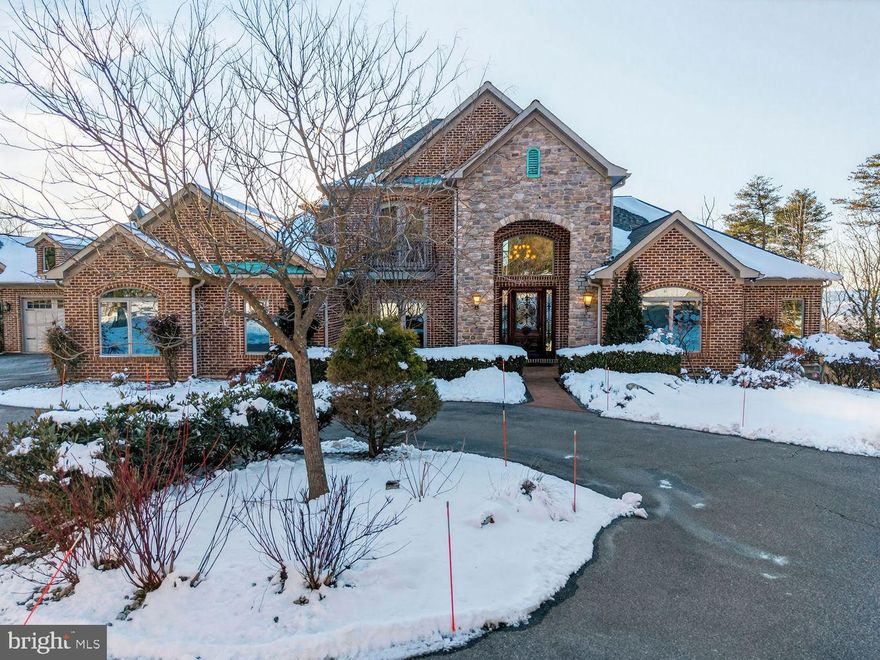 An extraordinary opportunity to own one of Frederick County’s most impressive custom estates. Secluded yet remarkably convenient, this one-of-a-kind residence sits on 7 private acres overlooking breathtaking views of Middletown Valley. Offering nearly 10,000 square feet of refined living space, the home blends privacy, sophistication, and modern innovation in a peaceful setting within a top-rated school district.

The main residence is thoughtfully designed for both grand entertaining and comfortable everyday living. A gourmet chef’s kitchen anchors the home, featuring custom granite countertops, cream cabinetry, premium Thermador appliances, an oversized island, and a sun-filled breakfast area. Formal living and dining rooms provide elegant gathering spaces, while the private office offers quiet productivity. The stunning family room showcases coffered ceilings, a fireplace, and a built-in bar — ideal for hosting.

Architectural details elevate every space, including a marble foyer with a dramatic curved staircase and wrought iron railings, rich hardwood floors, pocket doors, and extensive custom moldings throughout.

The luxurious main-level primary suite serves as a true retreat, complete with a sitting area, private balcony, fireplace, spa-inspired bath with steam shower, and a custom walk-in closet. Upstairs, three spacious bedrooms and two full baths offer comfort and privacy for family or guests.

A fully renovated in-law suite offers complete independent living with its own kitchen, laundry, full bath, bedroom with walk-in closet, and private deck — ideal for guests, extended family, or multigenerational living.

Designed with cutting-edge technology, the home is equipped with a state-of-the-art Savant home automation system with a dedicated in-home server, allowing seamless control of music, thermostats, televisions, alarm system, and intercoms for both front entrances. A fully integrated IT infrastructure includes a professional-grade server rack, firewalls, network switches, hardwired Cat 6 and fiber optic cabling, and 12 wireless access points providing exceptional indoor and outdoor coverage — future-proofed for speeds up to 10GB.

Security and peace of mind are paramount with a built-in surveillance system featuring 8–10 night vision cameras with motion monitoring capabilities. A whole-house water filtration system with carbon and UV purification enhances everyday living.

Outdoor spaces are equally impressive. A 40-foot heated fiberglass pool is surrounded by cool-to-the-touch travertine and complemented by a built-in audio system compatible with Sonos — perfect for entertaining. Multiple balconies, patios, and decks are positioned to capture the valley views, while evenings can be enjoyed around the newly installed smokeless firepit set within the wooded landscape, creating a serene and private retreat.

Additional highlights include a circular driveway, four-car garage, and convenient access to major commuter routes, shopping, and dining.