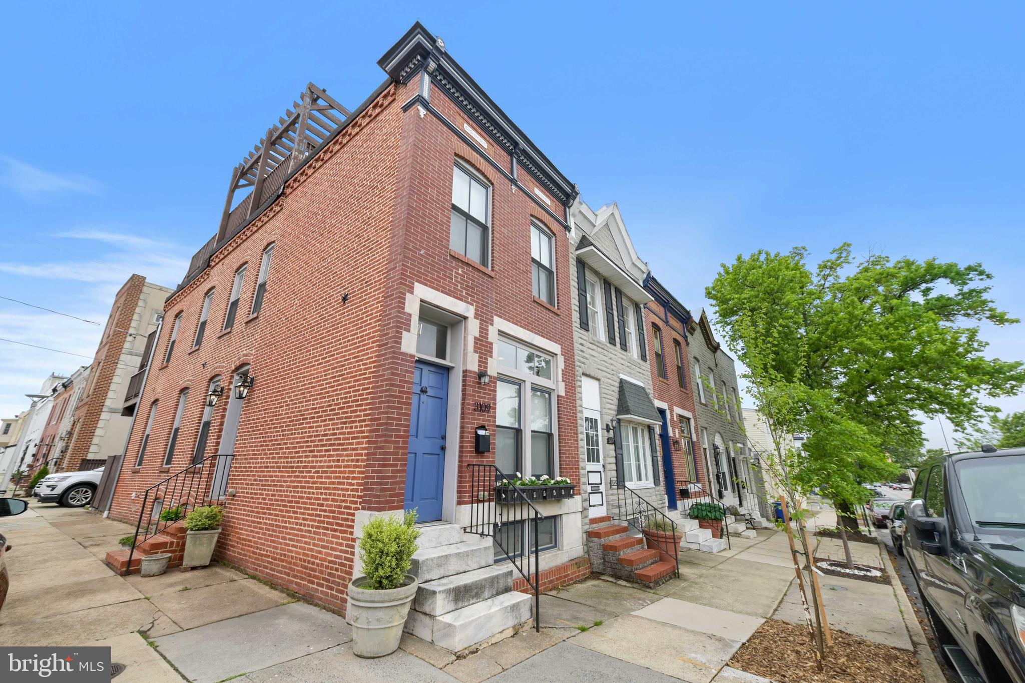 Stunning end unit with 3 bedrooms, 2 full baths and parking pad! This home has been meticulously maintained. Open entry level with living room, hardwood floors, oversized moldings, exposed brick, dining area, recessed lights, custom lighting and gourmet kitchen. The kitchen boasts a large kitchen island, 42 inch cabinets, granite counters and stainless steel appliances. Two bedrooms on the upper level with a beautiful bath with double vanity and tub/shower. Back bedroom has access to a deck and steps to an enormous roof top with unbelievable views of the city! Barn door to a finished lower level with a third bedroom and fully renovated bath with stand up shower. Great laundry with plenty of storage.
