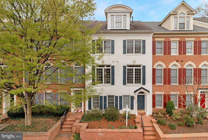 Premium lot in a picturesque neighborhood, this 3 bed, 3 full and 2 half bath, four-level townhome is ideally located ½ mile from the McLean Metro station, and minutes from Tysons Corner, the Silver Line Metro, downtown McLean, Wolf Trap and major commuter routes (66, 267, 495…). The main entrance brings you into a casual living space with a fireplace, custom built-ins, marble floors, a powder room and access to the rear load 2-car garage.  The main level, with high ceilings, hardwood floors and floor-to-ceilings windows on both ends, lets a ton of natural light into the living and dining rooms, kitchen with butlers pantry and breakfast nook with direct access to a second-floor balcony. On the upper level, the spacious primary ensuite bedroom with two large closets, offers plenty of space to include a home office or sitting area. A second bedroom, full bath and laundry complete this level. The loft level offers flexibility as a nanny suite, home office, kids playroom, exercise room and more with open living space, a bedroom, a full bath and access to the rooftop terrace with tree top views towards Tysons. McLean High School pyramid.