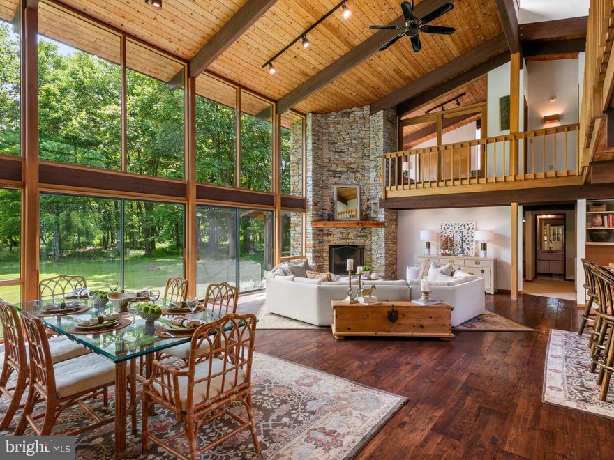 Discover unparalleled privacy and tranquility at 2174 Detweiler Road, an exquisite “ Acorn Deck” Home that masterfully combines traditional charm with mid-century contemporary sophistication. Nestled on over 10 acres of lush grounds, this almost 4000 square foot custom-built residence offers a unique living experience characterized by its post and beam construction, soaring ceilings, and expansive windows.
As you approach via the long circular driveway, you'll be captivated by the home's stunning exterior and its seamless integration with the natural surroundings. Designed by the original owner with materials sourced from across the country, this home features exposed Teak and Mahogany beams, a floor-to-ceiling custom stone wood burning fireplace, and a spacious open floor plan that includes a kitchen with an island, a dining area, and a large family room. The kitchen has been thoughtfully converted to a commercial-grade kitchen, licensed in Pennsylvania, ideal for the culinary enthusiast.
The home's design ensures a connection with nature, with an entire back wall of floor to ceiling windows and seamless sliding glass doors offering breathtaking views of passing deer and the expansive, lush property. Enjoy outdoor living in the screened-in back porch or the Green House, perfect for gardening enthusiasts. The interiors are accentuated by tongue and groove Cedar plank ceilings with track and recessed lighting, adding warmth and elegance to the space.
The meticulously maintained gardens surrounding the property enhance its beauty and provide a serene escape. This estate includes two lot-numbered parcels, both being sold together under Act 319/515, which provides significant tax savings to the new owner.
Seller invested upgrades include septic system installation (presently in process); screened-in porch; new wood flooring; new well pump; commercial exhaust fan for commercial oven; steam shower in main bath; water softening system; kitchen cabinets; kitchen and main bath faucets; geothermal heating and air conditioning, ensuring year-round comfort; all heating and air conditioning system ductork replaced and serviced by ultraviolet light and an osmosis filtration system in the humidifier and dehumidifier; green house; and roof replacement. This extraordinary property is more than just a home; it's a lifestyle. Easy access to Route 100 and 422, and a short commute to Allentown, Pottstown, Reading, and King of Prussia. Schedule your private tour today and experience the unmatched beauty and privacy of 2174 Detweiler Rd. Welcome home…