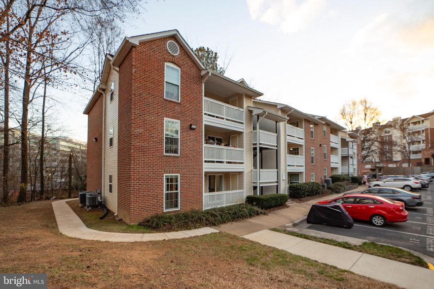 3.25% ASSUMABLE VA LOAN....and you don't have to be a veteran to qualify!!!  Welcome home to the ideally-sited Fountains at Mclean.  This beautifully updated 2 bedroom, 2 full bath condo offers 2 covered balconies, tree and water views, and wide array of amenities.  An open foyer welcomes you into a spacious living room with sliding glass doors opening to a large, covered balcony overlooking woodlands and the pond, perfect for outdoor entertaining and relaxing.  Chair railings and a sophisticated chandelier add a refined touch to the Dining Area that opens to the 2nd covered balcony.   The sparkling kitchen features classic white and glass front shaker cabinets, granite countertops, tile backsplash, a double farm sink, and stainless steel appliances.   This appealing floorplans offers open spaces, yet retains privacy with opposite-end bedrooms and an open-pass kitchen.    The spacious owner’s bedroom with walls of windows boasts plush carpet and contemporary lighted ceiling fan, a large walk-in closet, and updated en suite bath with quartz topped white shaker vanity, retiled tub/shower, and sleek fixtures.     On the opposite side of the unit, the 2nd bedroom offers plush carpet, lighted ceiling fan, a walk-in closet and is large enough to include an office desk.    Laundry room with full sized washer and dryer offers great additional storage space.     Rich hardwood floors, updated kitchen and baths, new HVAC and hot-water heater, and drapes and window blinds that convey create instant appeal for this move-in ready home.   The assigned parking space #13, just steps from the front door, adds convenience.     The building’s roof, doors, siding, paint, and retaining walls were all redone in 2020.      All this in a lovely community with a clubhouse, billiards, party rooms, a 24-hour fitness center, outdoor pool, and lush common grounds. Commuters will appreciate the easy access to nearby Metro, and I-495, Dulles Access Road, and Route 7. There is plenty diverse shopping, dining, and entertainment choices in every direction including Tyson’s Galleria. It’s a remarkable home in a spectacular location!