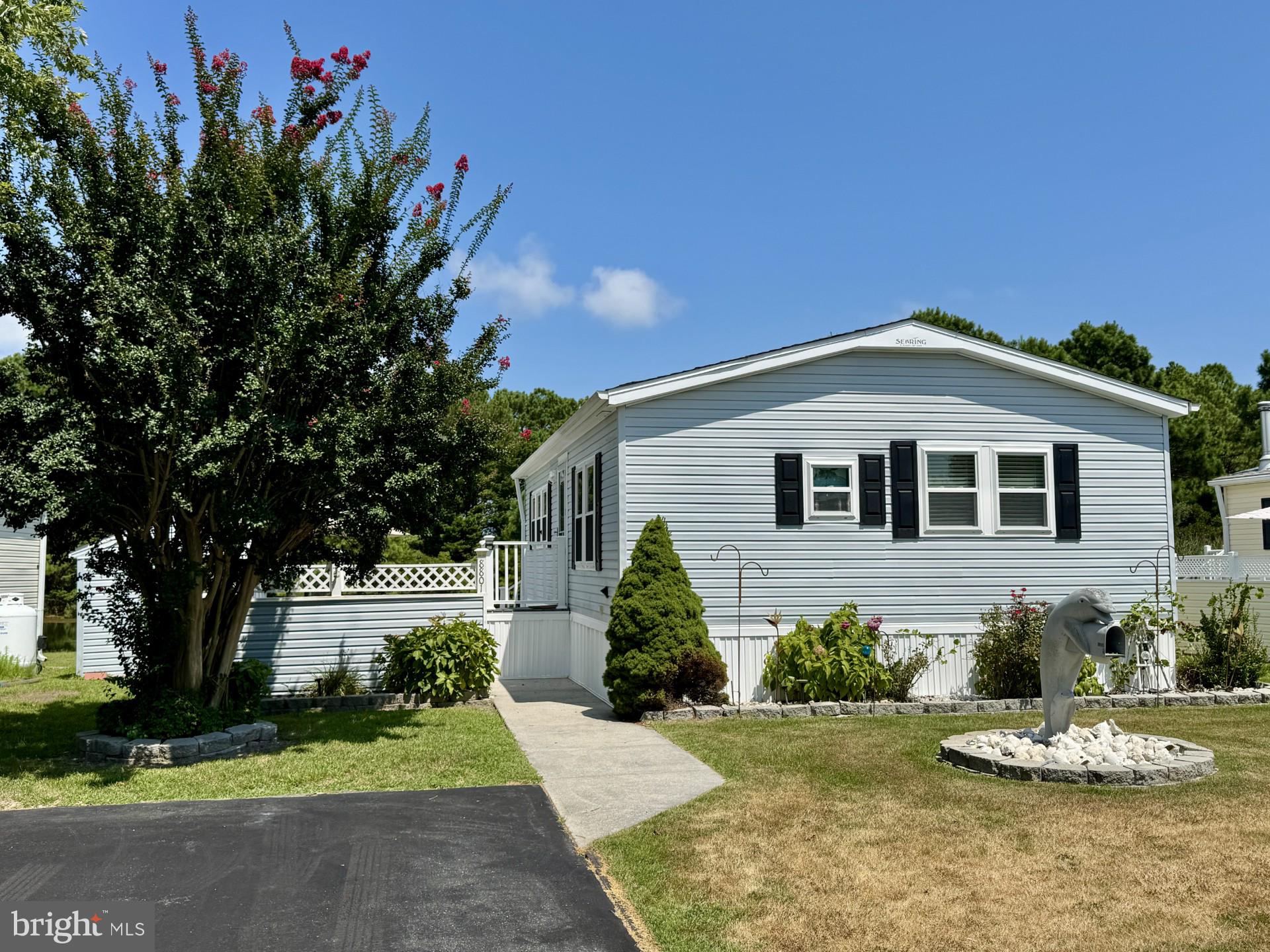 FABULOUS PRICE & PEACEFUL WATERVIEWS! If you're looking for seasonal living in a water-oriented community close to Assateague Island National Seashore and Ocean City, then 8801 Bay Ridge Drive is the perfect home for you! With beautiful WATER VIEWS that change with the seasons, this move-in ready home features 2 bedrooms, a spacious living room with sliders to the water beyond, an eat-in kitchen with breakfast bar, tiled back-splash, and plenty of cabinet & counter space, a full hallway bathroom, a stacked washer & dryer, and coat & storage closets. The home is fully furnished with Coastal decor and includes two queen-sized Sleep Number beds. There's off-street parking in the driveway, a huge side patio perfect for all of your outdoor entertaining, and a storage shed for water & beach toys. The patio is partially enclosed for added privacy. The ROOF was REPLACED in August 2024. The HVAC is 6 years old. Both sets of exterior steps were recently updated with composite decking and vinyl railings were installed. New kitchen sink faucet and new ceiling fans/lights installed in the bedrooms and living room. The Assateague Pointe community (less than 6 miles from Ocean City) offers residents a host of enviable amenities starting with Secure Entry into the Community, a Recreation Center with seasonal swimming pool, volleyball, and laundry facilities, a Clubhouse with a second outdoor pool, a Recreational Lake with grills, picnic tables, and paddle boats, Dog Park, Playground, Boat Storage area, basketball, shuffleboard, horseshoes, and corn hole, Recycle Station, and a 1000' Pier on Sinepuxent Bay (for fishing & crabbing). There's always something fun on the Community's Calendar so you can be as busy or relaxed as you choose! For added peace of mind, the Seller is offering the Buyer a one-year Home Warranty too. The golf cart also conveys with an acceptable offer!