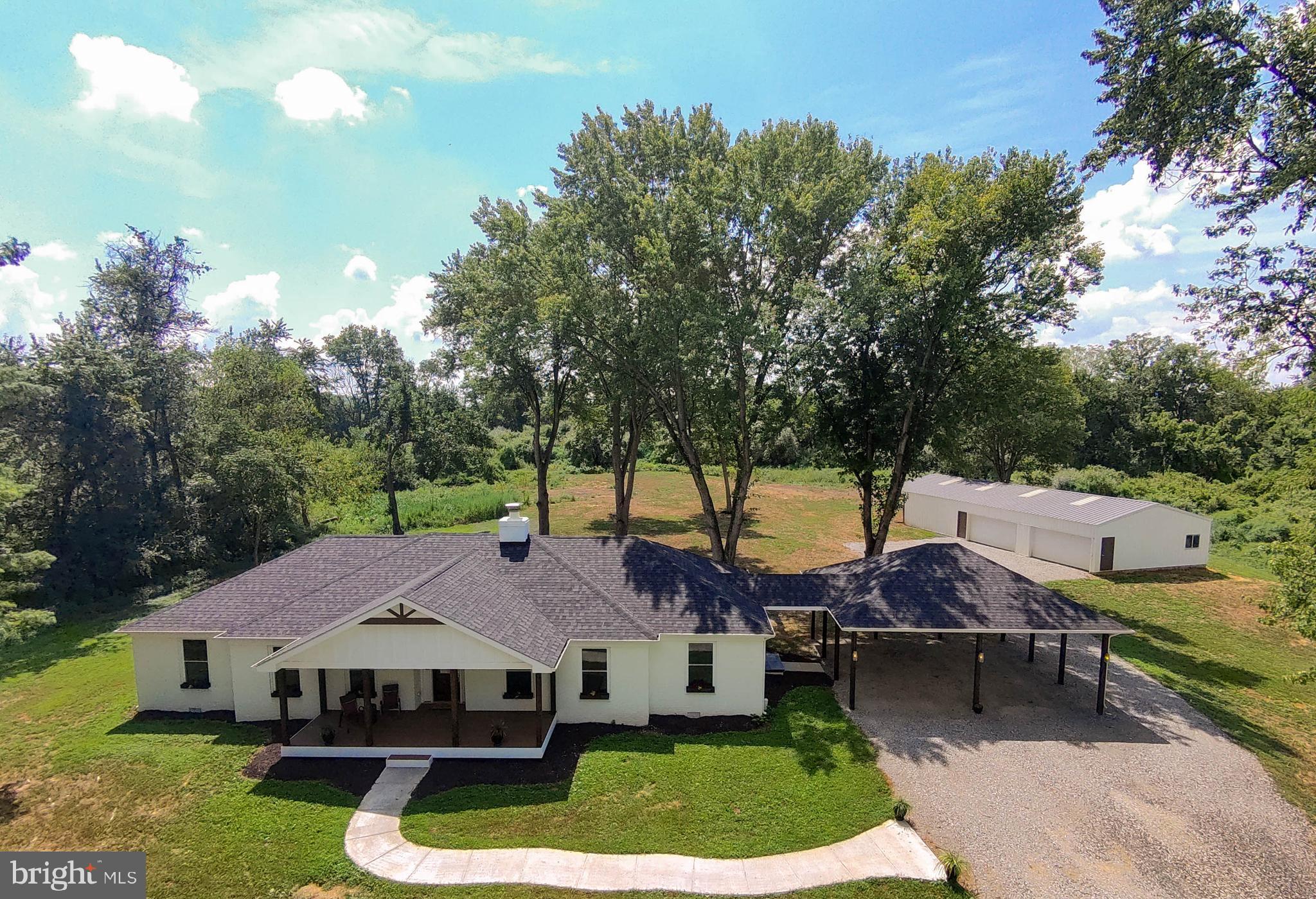 Stop the car and step inside to your newly-remodeled, stunning home! Nestled on an increasingly rare 10-acre lot, this gorgeous ranch-style home offers an inviting blend of luxury and comfort in a serene, rural setting. Built in 1978 and meticulously updated, the freshly-painted brick exterior exudes timeless elegance, with modern touches and a thoughtfully updated living space. Step inside to discover a light-filled, inviting atmosphere, highlighted by rich hardwood floors and an open floor plan that seamlessly connects the gourmet kitchen to the entertaining rooms. The kitchen is a chef's dream, featuring oodles of shaker-style cabinets for all of your every-day needs as well as all of your entertaining supplies, gorgeous granite countertops, an enormous 8ftx4ft island for socializing and casual meals with tons of additional storage. The sleek, white glass-front ENERGY STAR appliances are an elegant addition to a normally utilitarian space. Just IMAGINE the gatherings you could have in this open space! Or, enjoy cozy, private evenings relaxing by the brick wood-burning fireplace and unwinding in the luxurious primary suite, complete with a walk-in closet and a spa-like bathroom featuring a walk-in shower and a roll-under bathroom vanity for wheelchair access, if needed. All of the bathrooms are equipped with radiant-heat tile floors for cozy toes! There is a an office/den/craft room/reading room with a closet for storage and French doors for privacy. The outdoor spaces are equally relaxing, with a private, partly wooded yard that backs to trees, offering a tranquil escape. With 10 acres you could have riding trails for horses, walking trails for nature time, or leave it to habitat for privacy. Both the back patio and front porch invite you to savor the panoramic views of the yard and your expansive property. This home also offers an enormous oversized, detached garage/utility building that can be used for animals, hobbies, ample parking, or just extra storge, ensuring convenience for all your needs. Your new home is located in a peaceful, unrestricted area, with terrific commuter access, while also being near many surrounding activities such as hiking, history, river fun, wineries, breweries, and shopping. With Washington, D.C., Baltimore, and three international airports within a 1.5 hour drive the possibilities are endless for fun and full living! This home provides the perfect backdrop for an exclusive lifestyle, where nature and luxury coexist in perfect harmony. Experience the essence of refined country living in this exceptional property. Welcome Home to 2195 Engle Molers Road!