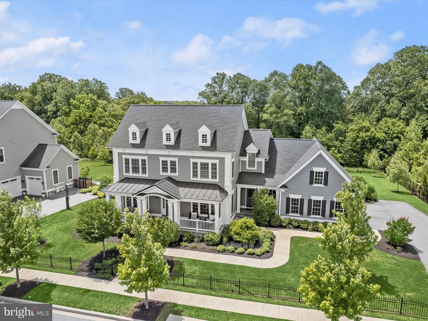 OFFER DEADLINE SUNDAY May 26th at 7pm **The tax records recorded the square footage of this home incorrectly. The correct total square footage is 6,467 as per third party measurements.** Welcome to one of the most prestigious addresses in Howard County. A premiere Estate Home offering in the exclusive Maple Lawn community does not become available very often. And this Mitchell & Best masterpiece happens to be tucked away in the highly desired Garden District, located on one of Maple Lawn’s most coveted streets. This rare opportunity presents the perfect blend of a serene, private, manor-like setting yet you’re still just a short walk from all the conveniences this award-winning, expertly planned community has to offer. Built in 2017, this Hawthorne model by the acclaimed home builder Mitchell & Best boasts 5 bedrooms, 4.5 bathrooms and nearly 6,500 total square feet. 

Interior main level highlights include a modern, functional open-concept floor plan and a magazine-worthy gourmet kitchen. The kitchen features a multitude of best-in-class upgrades; the sprawling, extended kitchen island with marble-look quartz countertop and custom stacked edge, upscale designer light fixtures by Circa, and upgraded, white shaker-style cabinetry which extends to the 10” ceilings. Custom, bespoke window coverings adorn the main level windows and the fireplace at the heart of the great room makes for the perfect family gathering place. 

The second floor presents a lavish primary suite with tray ceiling, recessed lighting and custom shades. A dedicated changing area leads into the spacious walk-in closet. The primary bathroom has all the accoutrements of a spa-like retreat; marble flooring, a large frameless shower, split vanities with marble tops and a freestanding bathtub. You’ll find custom shutters, a walk-in closet, and an en-suite bathroom in the guest room.  And the secondary bedrooms share a well appointed bathroom with custom basket weave floor tiles and a shaker style vanity with granite top. A bonus loft area and laundry room are also located upstairs. 

Discover a full walk-out basement downstairs allowing for tons of natural light making the entire lower level feel bright and airy. Enjoy movie night or the big game in the media room complete with in-wall and in-ceiling surround sound speakers. The large bedroom with walk-in closet also located on this level will make your family and guests feel comfortable and welcome. The basement is completed by a full bathroom and a large storage area.  

The possibilities to curate and customize your outdoor living space abound with an estate lot backing to breathtaking conservation area and mature trees. Lots of this size are very few and far between in Maple Lawn. The large driveway and side-entry 3-car garage provide plenty of parking and the extended family entrance with large walk-in closet will keep everyone organized and tidy. Zoned for highly rated Howard County Schools, conveniently located close to all major Baltimore/DC commuter routes, and with enviable amenities including a resort-style community pool, tennis courts, pickleball courts, basketball courts, state-of-the-art gym and more, you’ll quickly see why Maple Lawn is one of the most sought-after communities in the region and why 11670 Federal Street is truly one of its finest, flagship residences.