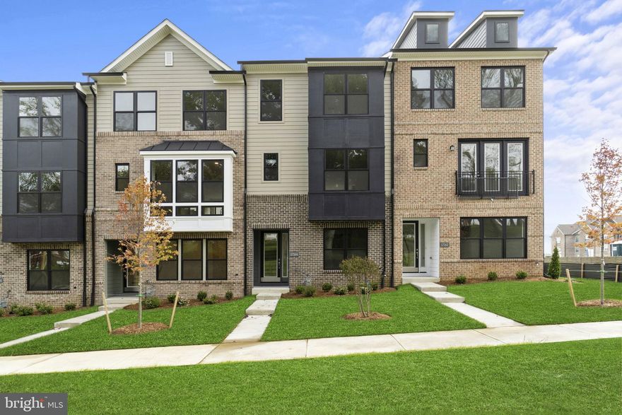$30,000 TOWARDS CLOSING ASSISTANCE  *Subject to the use of one of the builder-approved lenders.  Can be used for interest-rate buydowns! Restrictions apply.  

Welcome to your new home! Situated in the brand-new amenity rich and walkable neighborhood of Melford Town Center, conveniently located on the junction of Route 50 and 301 in the heart of Bowie, this location is just minutes away from Bowie Town Center, and a short commute to Washington DC, Annapolis, and Baltimore! This stunning two-car garage luxury townhome built by Mid-Atlantic Builders features three bedrooms, two full bathrooms, and two half bathrooms.  
Meticulous attention to detail is apparent as soon as you walk through the covered stoop entrance into the home complete with 9-foot ceilings, oak staircases, and black-trimmed Anderson windows that are thoughtfully installed throughout the home.  You’ll be greeted on the ground level by a comfortable open rec room with a powder room.  Enjoy relaxing or gathering in the massive open-concept kitchen area with a light and airy living room, dining room, and expansive outdoor deck. The third level is complete with a primary owner’s suite with a walk-in closet and two secondary bedrooms with a hall bath, with a coveted bedroom-level laundry.  Tremendous care has been taken architecturally to design multiple brick front exteriors that create variation but harmony amongst the units as well as the overall community.  To that end, each unit is constructed with varied elements such as canopies, window groupings, bays, front gables, and dormers to provide interest along the streetscapes.  *Must see!