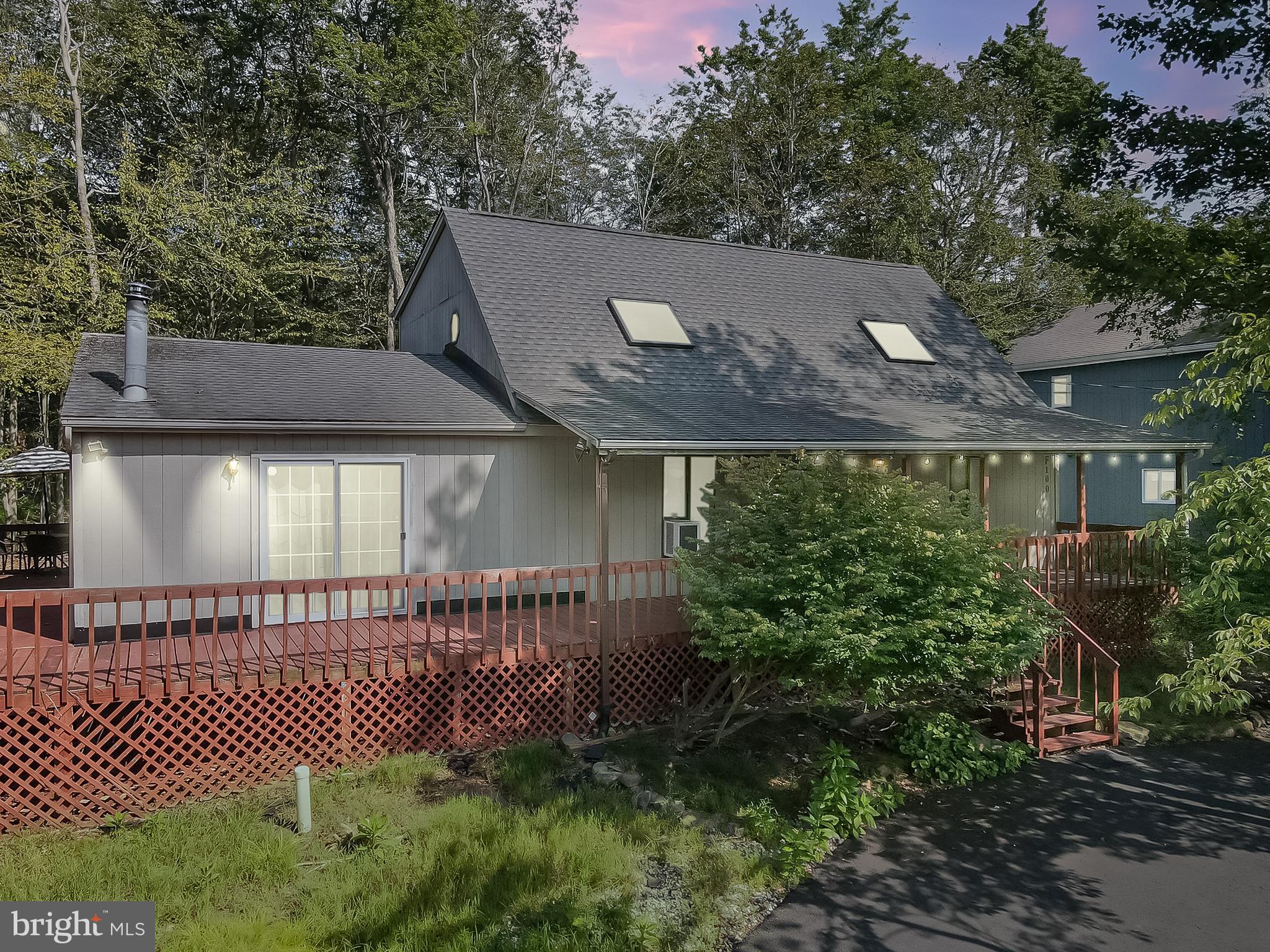 LOCATION!! LOCATION!! STEPS TO LAKE CAROBETH ACROSS THE STREET AND COMMUNITY BEACH ACCESS!!! SEASONAL LAKE VIEWS! 3 Bedroom 2.5 Bath with WOOD STOVE in the SPACIOUS 16.5 X16 Family Room! PRIMARY BEDROOM ENSUITE ON THE FIRST FLOOR! LAUNDRY also on the FIRST FLOOR! Wrap-around Deck and Covered Front Porch for those Warm Rainy Summer Days! Multiple Sliding Doors allowing an abundance of natural light and multiple access points to the deck! This is your next vacation Lake House or Short Term Rental Investment! Close to Pocono Attractions and Shopping! Convenient to highways and under 2 hrs to NYC! LOW TAXES! PUBLIC WATER & SEWER!! Community Amenities Include: Security; Gated; Barbecue; Clubhouse; Party Room; Picnic Area; Teen Center; Day Camp; Playground; Street Lights; Park; Recreation Room; Outdoor Pool; Children's Pool; Trail(s); Tennis Court(s); Pickleball; Basketball Court; Shuffleboard Court; Sport Court and Dog Park!! WOW! Schedule your Showing today!!