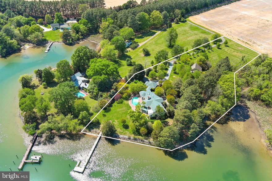 ‘Eagle’s Nest’ is an exceptional waterfront retreat overlooking Island Creek, just minutes from historic Oxford. Prime location with guest house and deep water (6.5' MLW). 
Privately sited on more than four acres amid mature trees and meticulously landscaped grounds, this impressive main residence (5324 SF)—completely rebuilt by Ilex Construction in 2008—offers four bedrooms, four full baths, and two half baths. Every room is generously sized and thoughtfully designed to capture expansive water views while providing elegant yet comfortable living.

The main level features beautifully appointed living spaces, including a formal living room with coffered ceiling, wood-burning fireplace, custom built-ins, wet bar, and sliding doors opening to the waterside patio. A formal dining room, enclosed by French doors, offers an inviting setting for entertaining.

At the heart of the home, the gourmet kitchen showcases a cathedral ceiling, large center island, top-of-the-line appliances, gas fireplace, spacious walk-in pantry, and custom built-ins—creating a warm and functional gathering space. The adjoining sunroom is filled with natural light and features vaulted ceilings, slate tile flooring, and sweeping water views, with glass doors opening to the patio and pool area. Nearby, a well-equipped mudroom, laundry room, and half bath add everyday convenience, along with a covered breezeway to the two-car garage.

The desirable main-level primary suite serves as a private retreat with tranquil water views, dual walk-in closets, and a luxurious en suite bath. Just off the primary suite corridor, a private office with custom built-ins and an additional powder room enhance the home’s thoughtful design.

Upstairs, three generously sized guest bedrooms each include en suite baths. A comfortable sitting area opens to a balcony overlooking Island Creek—an ideal place to relax and take in the serene setting.

In addition, a coveted one-bedroom, one-and-a-half-bath guest house (968 SF) includes a full kitchen, living room, and attached two-car garage—perfect for visitors, extended family, or flexible use.

Outdoor living is equally impressive, highlighted by a gunite swimming pool, expansive brick patio, mature landscaping, and extensive hardscaping designed to complement the waterfront setting. The private pier features two slips and a boat lift with 6.5' MLW along a protected, riprapped shoreline.

‘Eagle’s Nest’ presents a rare opportunity to enjoy refined Eastern Shore waterfront living just moments from Oxford.

New roof on main house (2025). New pool cover: Aqua pool service contract paid for-2026