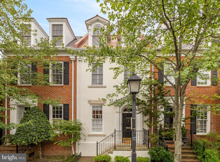 NEW LISTING! Gorgeous 3BR/3.5BA brick townhome with a sweet and sunny private brick patio and 2 assigned parking spots in an Old Town location that can’t be beat. One block to King Street! Exquisite architectural features fill the airy home with hardwood flooring throughout, grand archways, built-ins galore, two wood-burning fireplaces, and extensive millwork. Massive bay windows frame the open layout filling the home with natural light accented by recessed lighting. The stylish gourmet kitchen features Caesarstone countertops, crisp white cabinetry, stainless steel Bosch appliances, and generous storage, opening to the dining and living areas as well as outdoor space. The secluded brick patio creates an outdoor extension of the living room and offers the perfect spot to relax and entertain. A lovely half bath completes the impressive main level. Beautiful hardwood stairs lead to three peaceful bedroom suites on the home’s upper levels. The home’s relaxed elegant styling continues in the stunning primary suite with vaulted ceilings, built-ins, fireplace, and a luxuriously tiled en suite bath with a soaking tub, dual vanity, and a frameless glass waterfall shower. The top-level bedroom suite is dreamy with dormer windows with treetop views, a Murphy bed, great storage, and a full bathroom. A large storage unit is hidden behind the washer and dryer, a perfect spot for plastic bins and holiday decor. Two deeded parking spaces, secured bike storage and a spacious laundry room completes this must-see home. The home’s incomparable location offers the best of both worlds on a quiet one-way street only one block from the excitement of King Street. Top dining and unique shops surround the home moments from the Old Town Waterfront. Quickly finish errands with Target, Whole Foods, Trader Joe’s, CVS, Safeway, and Balducci’s close by, grab a coffee at Misha’s and start your weekend wandering. There is always something to see and do with the Old Town Farmers’ Market, art galleries, performances, seasonal events, parks, and trails nearby. At 808 Cameron Street, you really can have it all! Pets are welcome, too.