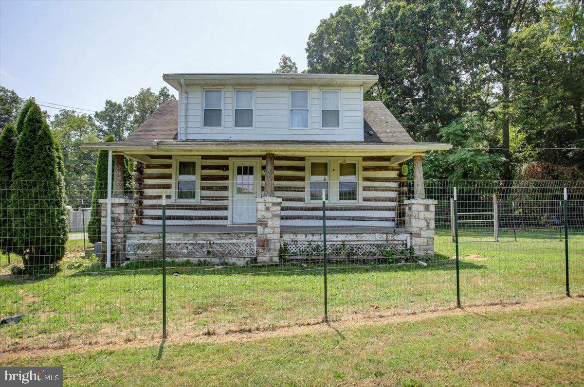 Cape Cod Cabin Style home offering 1,092 square feet of living space with 3 bedrooms and 1.5 baths. This 1.11 acres of property is tucked away against a sylvan setting and steps from a babbling spring. Has an attached garage for parking and storage and a larger detached garage for additional parking and storage or a good area for a workshop. Comes with a large driveway that has been cleared for more room. Home has been converted to a 3-zone system for heating; upstairs, main floor, and basement. Basement has been partially renovated. Newer water filtration system, water softener, well pump, and water heater within the last 2-3 years. All cars, parts, and miscellaneous items will be removed from property. Fencing around front porch and property can be removed by seller by request. Conventional or Cash financing only.