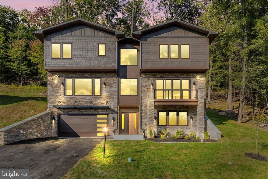 Currently under construction in the highly sought-after Aspen subdivision of Lake Linganore, this high-end contemporary home blends modern design with a true lake lifestyle. Clean architectural lines, expansive windows, and a striking mixed-material exterior create a bold yet timeless presence, while the elevated setting is designed to capture scenic lake views.

Inside, the home is planned for both everyday comfort and upscale entertaining, featuring an open concept layout filled with natural light and thoughtfully designed living spaces. The modern design emphasizes connection to the outdoors, bringing in the surrounding scenery and creating a bright, airy atmosphere throughout.

Living in Lake Linganore means more than just a home, it’s a lifestyle. Residents enjoy access to private beaches, multiple pools, miles of hiking and nature trails, playgrounds, sports fields, pickleball courts, farmers markets, summer concerts, and community fireworks events.

A rare opportunity to own new construction in Aspen, where contemporary architecture meets resort-style lake living.