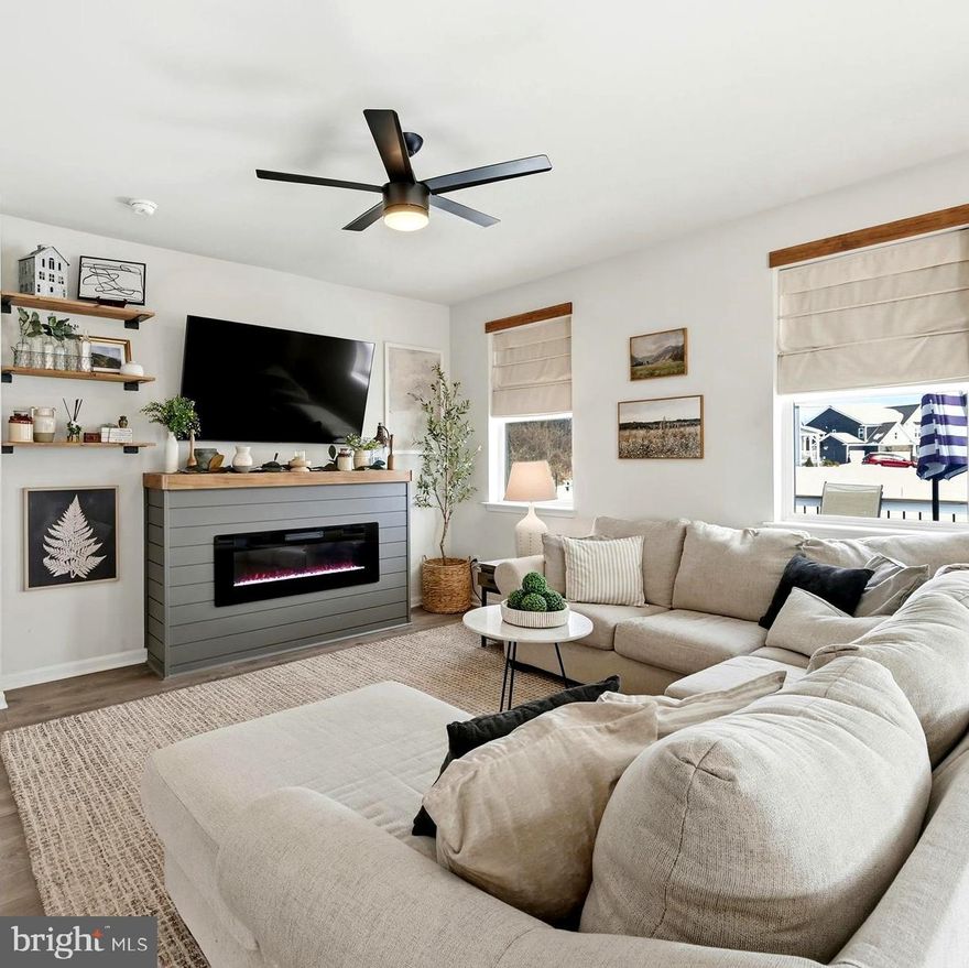 Welcome home to this nearly new DR Horton home, just 2.5 years young, located in the sought-after Hermitage community minutes from historic downtown Berryville. Offering 2,798 finished square feet, this beautifully designed 4-bedroom, 3-full-bath home delivers the perfect blend of elegant design and functional main-level living.

The main level features three generously sized bedrooms and two full baths, including a spacious primary suite, making everyday living effortless. The open-concept layout is filled with natural light and showcases upgraded luxury vinyl plank flooring throughout the main living areas and primary bedroom. Thoughtful, professionally selected design details elevate the space, including stylish light fixtures, upgraded cabinet hardware, custom mirrors and faucets, and extensive millwork accents. The living room is anchored by a show-stopping fireplace, creating a warm and inviting focal point for gatherings.

The kitchen is both beautiful and practical, offering ample cabinetry, modern finishes, a large center island, and seamless flow into the dining and living areas, ideal for entertaining or everyday living.

The fully finished lower level expands the living space with a large recreation room featuring custom cabinetry, a fourth bedroom, and a full bath, making it perfect for guests or multigenerational living. A huge unfinished storage and utility room provides exceptional space rarely found in newer homes.

The home is also equipped with a Qolsys smart home security control panel, integrated with the video doorbell, rear security camera, and indoor alarm system, providing centralized control of the home’s security features. The system offers a strong foundation for future smart home enhancements, with the ability to expand to lighting, switches, and outlets if desired.

Step outside and enjoy your private backyard retreat featuring a spacious 10’ x 20’ Trex deck with stairs, leading down to a paver patio and fenced yard, perfect for relaxing, entertaining, or enjoying the peaceful mountain views.

This home offers the benefits of newer construction with upgrades already completed. It is move-in ready, thoughtfully designed, and beautifully maintained. A rare opportunity for main-level living in a prime Berryville location.