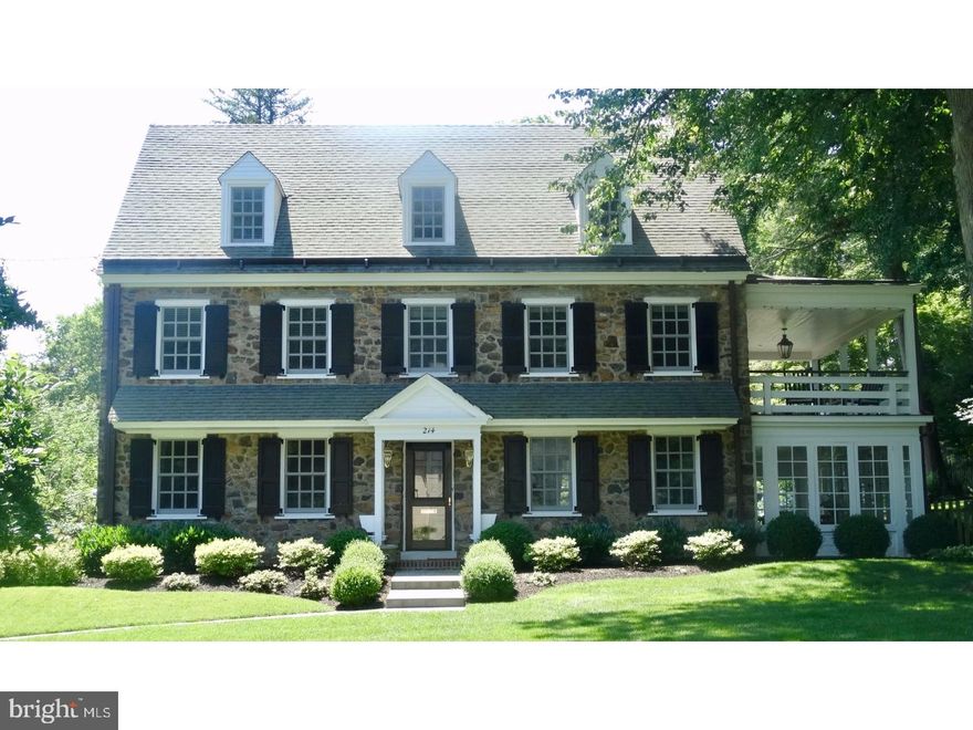 Classic Stone Colonial on one of the most desirable streets in South Wayne.  This grand, 3-story home has all the qualities of a bygone era with all the amenities of today's world. Fine architectural details highlight the timelessness of this home including beautiful mill-work, deep windowsills, arched doorways, hardwood floors and new Marvin  "architectural series" windows throughout.  A Through Center Hall leads to a Living Room with built-in farmhouse cabinetry and gas fireplace. French doors lead to a heated Sun Room with brick floor and Sliding glass door to the gardens. The remodeled Gourmet Kitchen features double thick Caesarstone counter-tops, a gas cook-top, built in refrigerator and oven /microwave. On the Second Floor, you will find a Master Bedroom including an all new Master Bath with a soaking tub, marble stall shower and a heated tile floor. A beautiful newly rebuilt Covered Porch can be accessed off the Master Bedroom allowing for quiet mornings or a lovely retreat after a long day. You may descend the attached outside stairway to view the gardens below and enjoy Al Fresco dining on the raised flagstone patio. The 2nd Floor also has a separate In-Law or Au Pair suite with new marble bath and may be accessed from a back stairway. An additional 2nd Floor Laundry, Sitting Room and 3rd Bedroom complete this level. Upstairs on the 3rd Floor are 2 additional Bedrooms and new Hall Bath and Storage. Other features include central air on all 3 floors; gas, hot-water heat, whole house generator; water-proofed basement; large storage/cedar closet in Basement where you will also find a 2nd Laundry,  extra storage shelving and an outside access. There is a 1 1/2 car attached heated Garage.  Professional landscaping and an abundance of blooms create a serene setting for your outside pleasure. A truly remarkable home in popular "Walk to Wayne" neighborhood. Please note the pool on the property is being sold "as-is".  Owner has never used it.