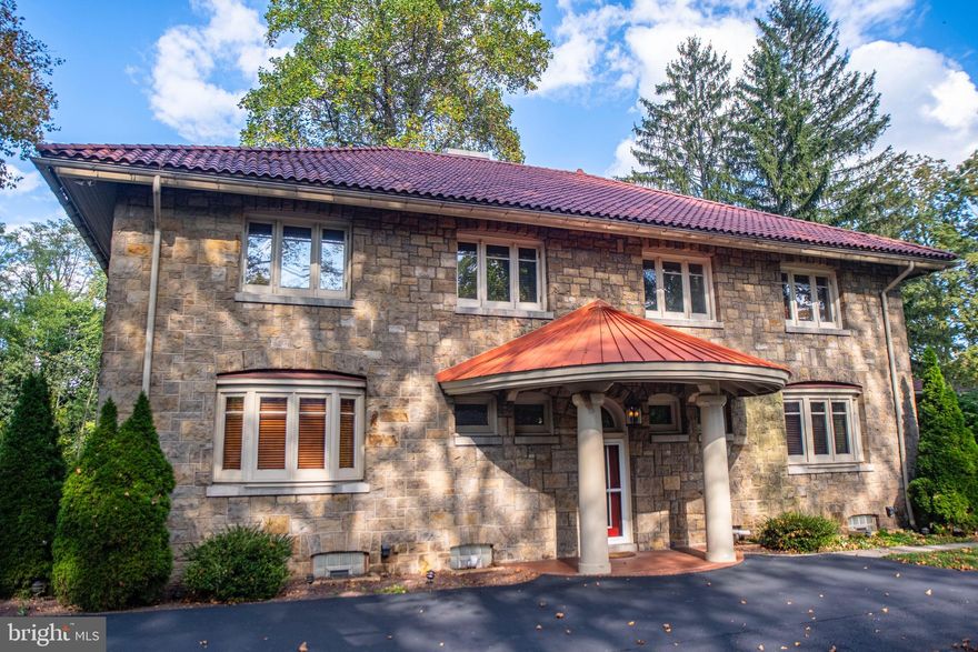 A distinguished Italian Renaissance Revival residence, this home seamlessly blends timeless architecture with refined modern comforts. Step inside to discover two gracious living rooms, each anchored by its own fireplace, and a chef's kitchen appointed with a Sub-Zero Pro refrigerator and freezer, Viking range, island sink, trash compactor, and exquisite cabinetry. The second floor hosts four bedrooms, including a luxurious owner's suite featuring a walk-in closet, oversized tiled shower, and heated floors. A private en-suite bedroom, an additional full bath, and a large laundry room complete this level. The finished attic and basement provide versatile living, storage, and entertaining spaces. Set on nearly an acre, the property includes a three-car garage, existing pool hookups, and a first-floor balcony. Designed with both elegance and efficiency in mind, this exceptional residence offers a rare opportunity to own a piece of architectural history, beautifully updated for today's lifestyle.