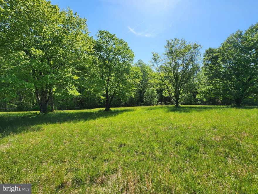 2 ACRE TREE'D LOT ON LAND SLOPING TO CREEK/STREAM.