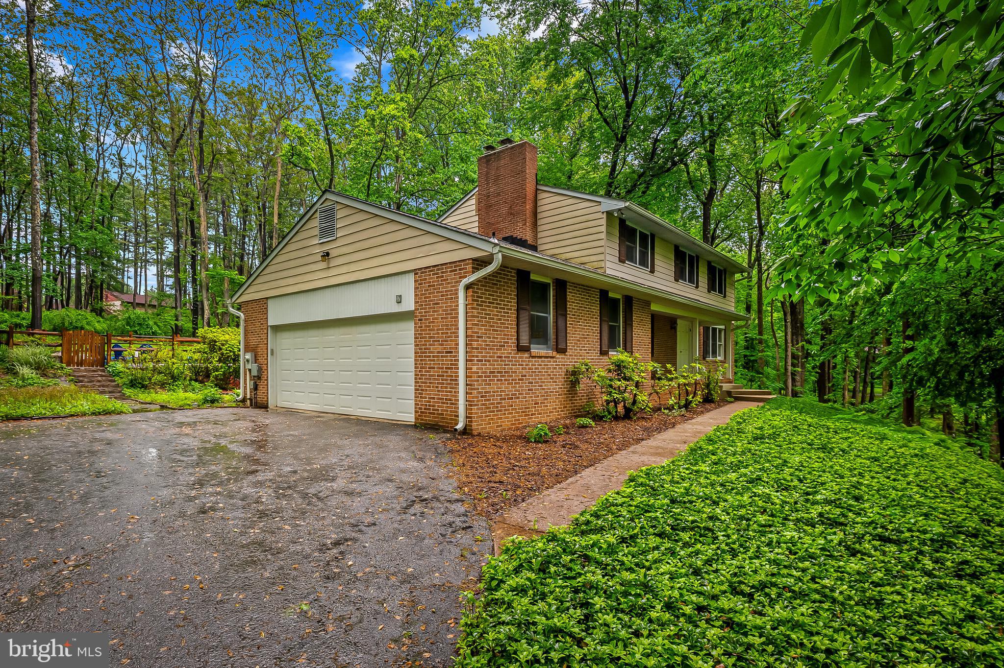 This is a lush, forested 2.5 acre property, almost like living in a state park, but with easy access to town, shopping areas and highways. Includes a large screened-in porch that is a peaceful oasis for relaxation, meditation, recreation. The roof, water heater, and swimming pool fence are all relatively new. The deck and the in-ground swimming pool itself have also been rebuilt (including coping stones, tiles, and plaster). Many plants, including native plants, both volunteers and intentional, adorn the property. Dine alfresco on your screened in porch, swim under the stars in the in-ground pool. , dig and plant to your hearts content. On the inside of the house, there are granite countertops in the eat-in kitchen; spacious dining room open to the living room; first floor laundry; family room with fireplace; hardwood floors; fully finished lower level with recreation room and additional office, extensive storage area; four bedrooms on second floor; and a large two car garage. Home being sold "As Is"