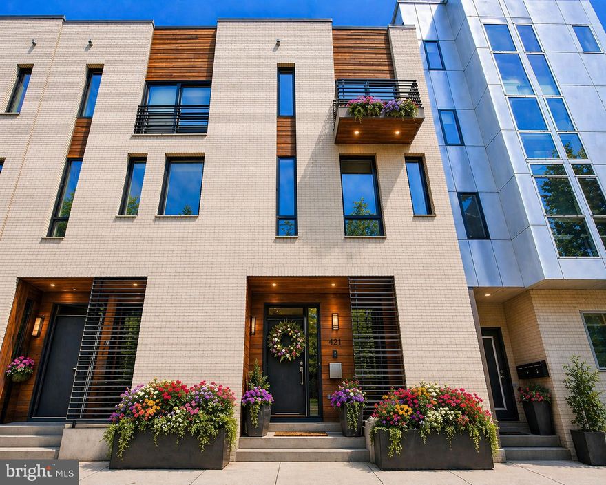 Welcome to 421 Wallace Street — where refined city living meets elevated design on one of Philadelphia's most coveted cobblestone streets in the heart of desirable Northern Liberties. This exceptional 4-bedroom, 3.5-bath corner townhouse offers a seamless blend of sophistication, comfort, and intentional living, and comes complete with 1 car deeded gated parking located in the rear of the home — a rare and highly sought-after city luxury. Checking every box for the discerning buyer, this home is designed to impress from the moment you arrive.

Step inside to sun-drenched interiors, clean architectural lines, and an open-concept main level designed to both wow and function effortlessly. The generously sized living area flows beautifully into a true chef's kitchen, thoughtfully appointed with built-in stainless-steel appliances, sleek quartz countertops, and an oversized island perfect for entertaining family and friends. Every space feels curated yet inviting — the ideal balance for modern luxury living.

The fully finished basement extends your living experience with limitless possibility — a private lounge, media room, fitness studio, or executive home office — complemented by additional storage to keep life beautifully organized. Calling all workout enthusiasts: this lower level is spacious enough to accommodate both your personal gym and a dedicated work-from-home setup.

Generously sized bedrooms offer exceptional closet space and abundant natural light throughout. The entire third floor is dedicated to a luxurious primary suite — a true private sanctuary featuring a grand walk-in closet, a stunning spa-inspired tiled bath, and a charming private deck perfect for morning coffee or unwinding at the end of the day. Ascend one more flight to discover the fourth-floor entertainer's dream — a spacious bedroom paired with a stylish top-floor wet bar that flows seamlessly out to a breathtaking rooftop patio delivering sweeping skyline views. Whether hosting cocktails under the stars or enjoying quiet evenings in the city sky, this top-floor retreat is truly one of a kind. A private backyard patio adds yet another coveted outdoor space — giving this home three distinct outdoor retreats, a rare combination in the city.

Designed with everyday convenience in mind, this home features dual-entry access from both the rear and the right side of the property, making daily living effortless. Year-round comfort is delivered through a dual-zone HVAC system offering efficient, customized climate control on every level, while second-floor laundry adds another layer of thoughtful functionality right where you need it most. With 18 months remaining on the tax abatement, you'll enjoy significant savings — and for added peace of mind, the seller is generously offering a 1-year home warranty to the new owner.

Perfectly positioned in vibrant Northern Liberties, 421 Wallace Street places you steps from Philadelphia's most celebrated destinations. Stroll to The Piazza at Schmidt's Commons for shopping, events, and outdoor concerts, or grab brunch at neighborhood favorites like Honey's Sit 'N Eat, Cake Life Bake Shop, and Bourbon & Branch. Coffee lovers will appreciate ReAnimator Coffee and One Shot Café just around the corner. Foodies can savor renowned spots like Heritage, Standard Tap, North Bowl, and Silk City Diner, while craft beer enthusiasts will love Yards Brewing Company and Love City Brewing nearby. Enjoy green space and riverfront views at Liberty Lands Park and Penn Treaty Park, or take a quick walk to Old City, Fishtown, and Center City for endless dining, arts, and entertainment options.

For the buyer who values design, comfort, and elevated living, this is the one. Experience it. Own it. Live it.