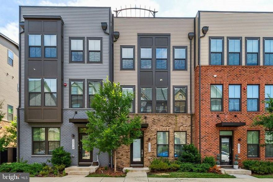Incredible 4-level contemporary townhome with rooftop terrace, walking distance to the new Ashburn Station Metro!  Built in 2019 with all the upgrades and luxurious finishes you could imagine, and in the heart of Brambleton!  Stunning, open kitchen with quartz countertops and white cabinets, oversized island with breakfast bar and pendant lights, and stainless steel appliances.  Enjoy the sleek gas fireplace on the covered balcony off the family room!  Owners' Suite offers a fantastic walk-in closet with drawers, shelves, and organizers, plus a deluxe bathroom with dual vanities, dual shower heads and bench!  Upper-level laundry room includes front-loading washer and dryer.  The top floor offers a 4th BR, 3rd full bath, and bonus room that opens onto the rooftop terrace!  Tech upgrades include 2-zone HVAC, digital thermostats, and electric vehicle charging station in garage.  Westmoore at Moorefield will offer residents use of their community center, resort-style pool, fitness center, amphitheater, dog park, tot lots, walking trails, and more!  Brambleton and Ashburn offer all the dining, shopping, and entertainment options you could hope for!  Commuters will love the location with easy access to Dulles Airport, the Dulles Toll Rd, and Metro's new Ashburn Station.