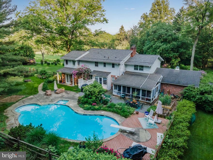 This beautiful home has a park-like setting on 1.72 acres, complete with a bubbling brook and carefully curated hardscape and landscaping. Sitting back from the road, this well-manicured level lot provides a picture-perfect frame for this large 4 bedroom, 2.5 bath, 2 story sanctuary with almost 3,000 sqft and plenty of room to roam. Sit and relax on the large covered front porch or enter the flagstone foyer. To the left is an oversized family room with radiant floor heating and a gas fireplace with a beautiful hearth and stone, which leads to a large tiled sunroom that overlooks the in-ground pool and a large patio. The first floor also has a double living room with a huge bay window....there are no bad views from any room in this home! The kitchen is complete with granite countertops, stainless steel appliances, and a gas range and oven. Upstairs, the rooms get even bigger. The HUGE primary bedroom has a wall of windows that wrap around 3 sides for the perfect breeze. There are also walk-in closets, a built-in closet, and a wall of closets for unparalleled space and storage. The updated primary en suite has a beautiful soaking tub, a glass shower, and a built-in shaver-height stone top vanity. Just down the hall is a second primary bedroom, reminiscent of a suite at an upscale hotel. Two other large bedrooms round out the second floor, along with a full bathroom including an updated stone top shaver-height vanity and decorative subway tile backsplash. The backyard can be accessed from several points within the home and has a beautiful oasis feel with herb gardens, large stone patio, a 9' deep cement in-ground pool, and an attached pool house for the mechanicals and equipment. Privacy and peace are the words to describe this home, whether you are relaxing, entertaining, or gardening. Because of the care and attention given to the maintenance, updates and improvements to this home and land, the sum is truly greater than the parts. All this AND includes a 1 Year Home Warranty for the new owner. Schedule your tour today!