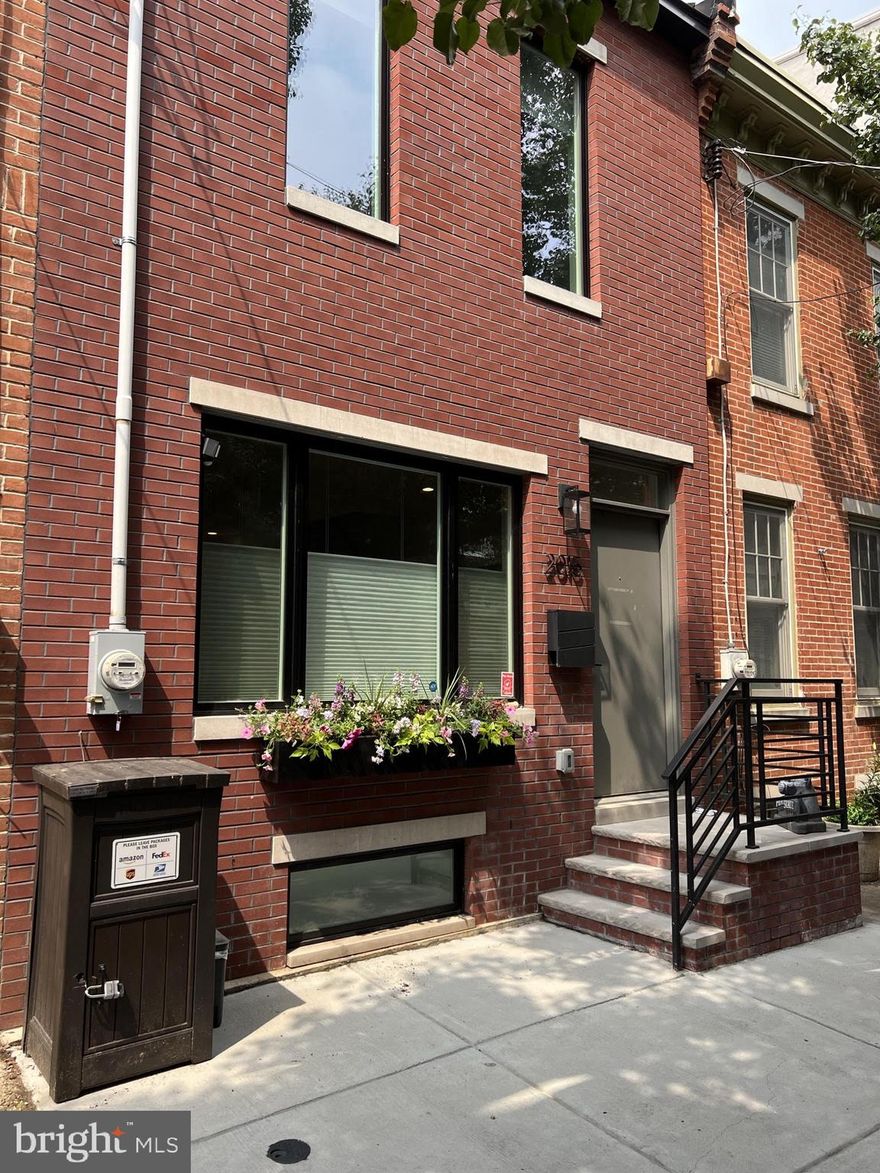 A hidden gem nestled on a quiet, tree-lined block in Graduate Hospital, 2015 Saint Albans St is a modern 2,000+sqft home expertly rehabbed in 2021 by respected neighborhood builders Hybar Construction and meticulously maintained by prideful owners since. This 4 bedroom, 3 bathroom residence encompasses a rarely offered 16ftx60ft oversized lot with private parking, a finished basement, a roof deck, luxury finishes throughout, and 7 years remaining on the original full 10-year non-decreasing tax abatement. You're welcomed out front by a handsome red brick facade accented by a lively window box and a raised entry. Inside, the bright and airy main level has an open layout with high ceilings and hardwood floors. Tall Pella windows, with Hunter Douglas treatments, fill the living room with natural light, while a light fixture helps define the separate dining area. The gleaming gourmet kitchen is fitted with custom two-tone wood and white cabinetry, quartz waterfall countertops, high-end stainless steel appliances, and a center island with seating. A pair of Pella sliding doors lead to the rear driveway, which can easily accommodate a large SUV along with a grill and storage. There's more living space in the finished basement that takes full advantage of the extra lot depth and heated floors, with 8+ft ceilings providing, an above-ground feel. It has a bonus space ideal for a den or playroom, a full bathroom with heated floors, a guest bedroom that can double as a home gym, and tons of storage. Up on the second level, you'll find spacious, bright bedrooms on opposite ends. A laundry closet, a linen closet, and a sleek full bathroom with a double vanity sit off the hall. The third level is dedicated to the primary suite. It features a large sunlit bedroom, custom walk-in and reach-in closets, and a luxurious spa-like bathroom adorned with heated floors, a double vanity, a soaking tub, and a glass-enclosed rainfall shower. Topping off the home is an expansive roof deck showcasing unobstructed panoramic skyline views, sure to be your go-to spot for hosting family and friends on good weather days. Mechanicals include central a/c, gas heat, and a tankless gas water heater. In addition to everything inside, 2015 Saint Albans St's fantastic Graduate Hospital location earns a Walk Score of 90! Idyllic Rittenhouse Square and the extensive Schuylkill River Trail are both a short stroll away. The neighborhood has friendly cafes and restaurants to explore, and nearby South St is lined with markets and shops. Plus, getting around is easy with convenient access to public transit, Washington Ave, I-76, and The University of Penn. Schedule your in-person today!