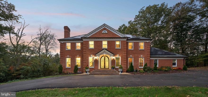 The essence of luxury living, this classic brick colonial is sited on 2.57 acres of serenity less than two miles from Potomac Village.  With four fireplaces, exquisite moldings, ten Maria Theresa designer chandeliers, and rich hardwood and bamboo flooring, the home offers a beautiful backdrop for traditional or contemporary furnishings and art.  Introduced by a grand two-story marble foyer, the interior has been extensively renovated and offers elegant formal rooms, six bedrooms, five renovated full baths and a main-level library wrapped in wood.   The kitchen is every chef's dream, with new quartz counters and cabinetry and Viking appliances. Accented by a custom backsplash, an expansive center island, and built-in wine nooks, the kitchen leads to a sun-filled breakfast area and family room.  The family room is appointed with a beamed ceiling and wood-burning fireplace, and also opens to the expansive deck.  There are five upper level bedrooms and three full baths.  The primary bedroom includes a spa-inspired bath with inlaid custom tile, heated floors, a rainfall shower and jetted tub and doors to a balcony overlooking the yard. Filled with natural light, the walkout lower level offers a spacious entertainment room accented with a floor-to-ceiling stone wall and fireplace and a full bar.  There is a beautiful bedroom and full bath as well.  The lower level is complete with a full kitchen, adding every amenity for entertaining, overnight guests or an au-pair. Step outside to a summer kitchen and grill area with appliances and a gazebo, a level lawn space and a surround of trees.  Tucked into the property, a trail leads to a private tennis court. With every consideration for carefree living, the home offers all new windows and patio doors, a new roof of Luxury Grand Manor slate-like shingles, 2 in-wall surround sound systems, a washer and dryer on all three floors, and two large capacity HVAC units.  Only moments to Potomac Village’s restaurants and shops, excellent public and private schools, and everything ringing the nation’s capital, this home offers a perfect blend of form, function and resort-style living!