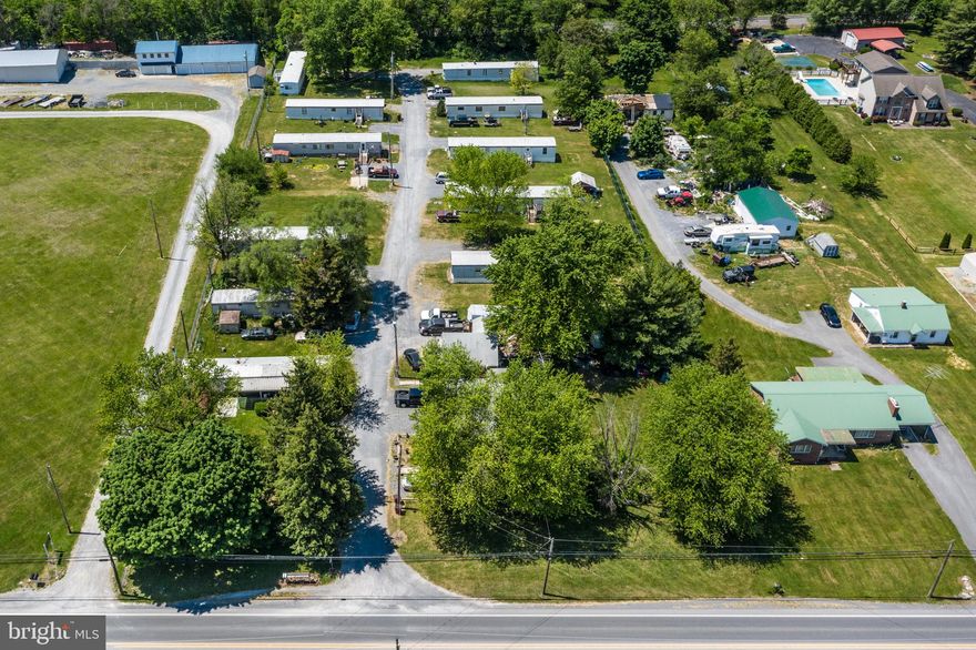 A Great opportunity for the investment enthusiast to own a small mobile home park sited along Route 11 in Inwood WV.  The park also includes 2 single family homes so you can live onsite and watch your investment grow.  All Mobiles are seller owned with the exception of one, who lot rents only.  All sites are individually electric metered as well as water & sewer metered.  Units range in age but are all maintained as needed.  Monthly income is $7800.00.  Great road frontage on Route 11 would allow additional growth into commercial spots.  Think of the possibilities.  What is your vision.  Property is being sold as is, where is.  Showings are by appointment only.  Purchaser to perform all due diligence.  Elementary school should be verified.  All units are currently rented.
